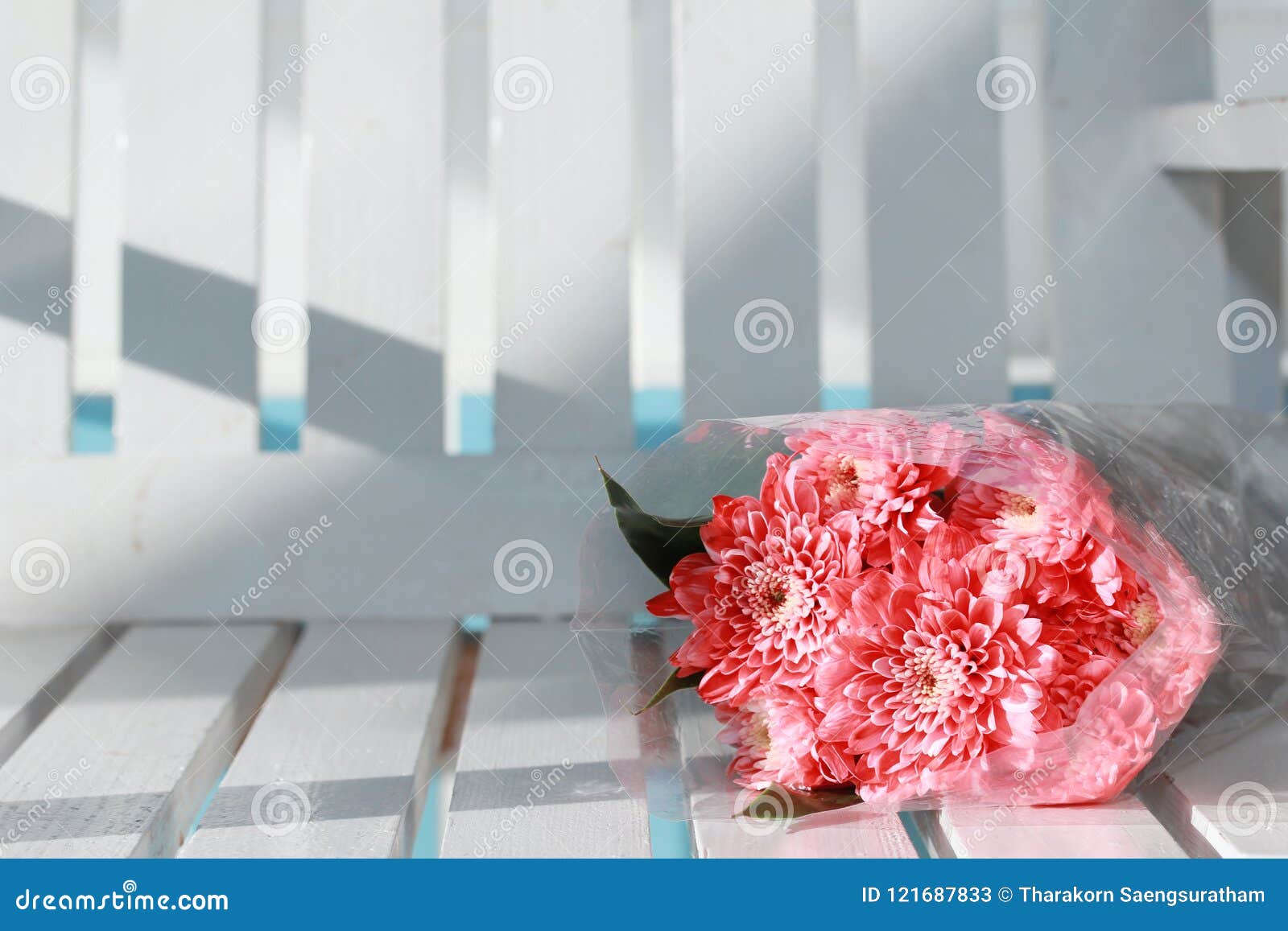 colorful pink rose flowers bouquet is a combination rests on white wood.