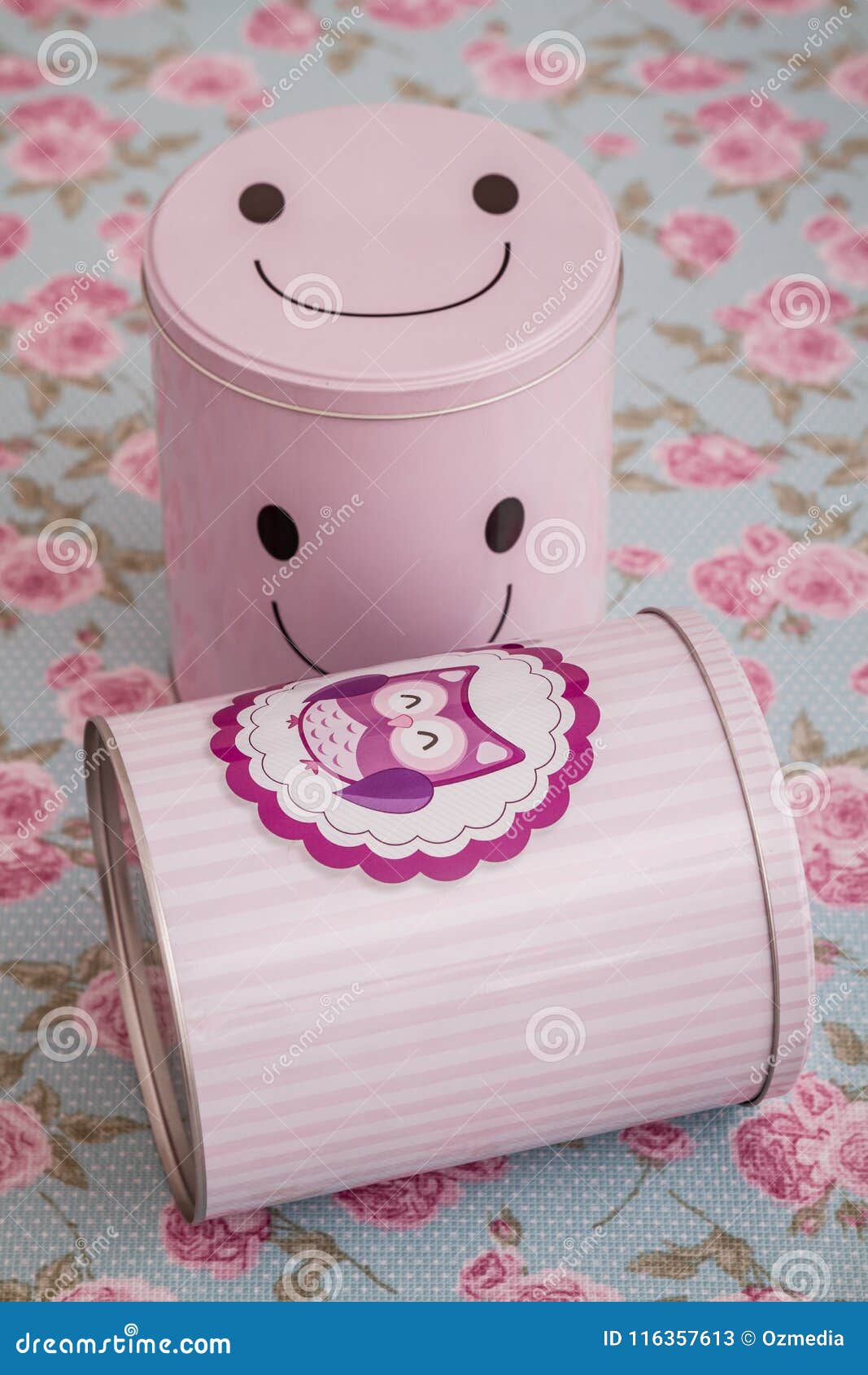 Colorful Pink Tin Storage Containers on Floral Pattern Stock Image