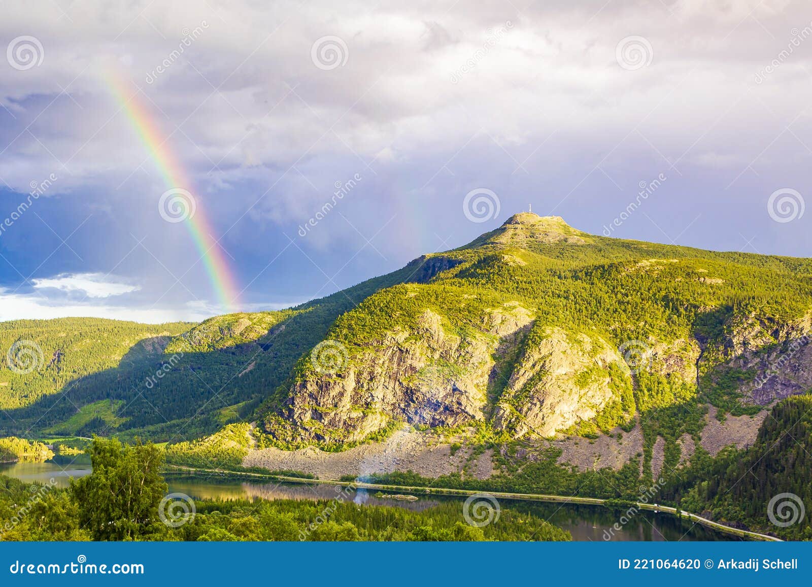 colorful rainbow over the lake vangsmjose and mountain panorama norway