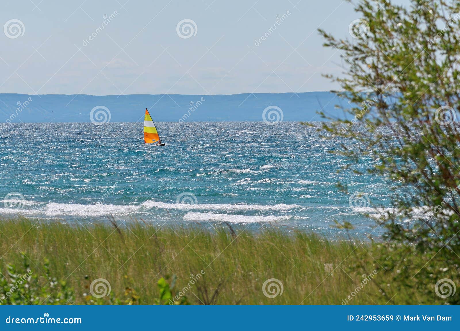 colorful sailboat sailing on a windy sunny summer day on georgian bay