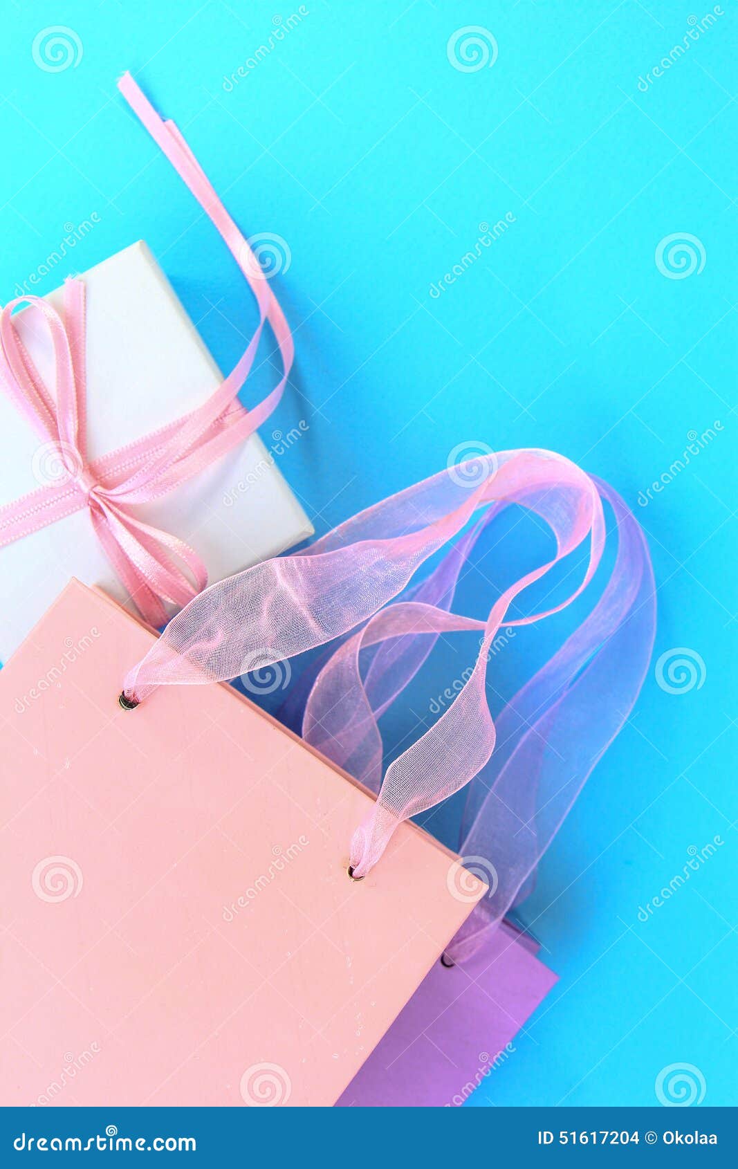 Colorful Shopping Bags and Gift Box on Blue Background Stock Photo