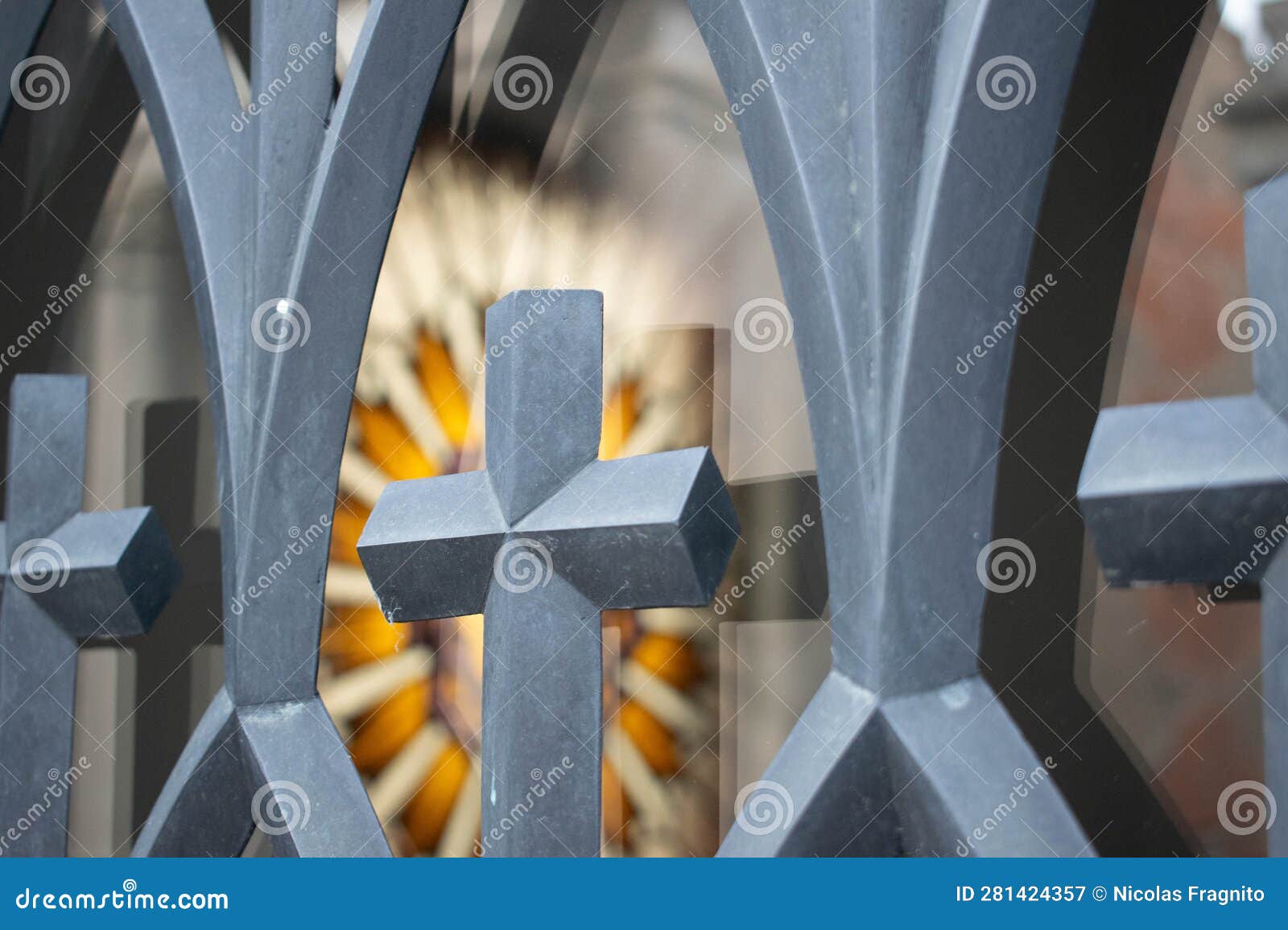 colorful stained glass window seen through a fence in recoleta cemetery in argentina