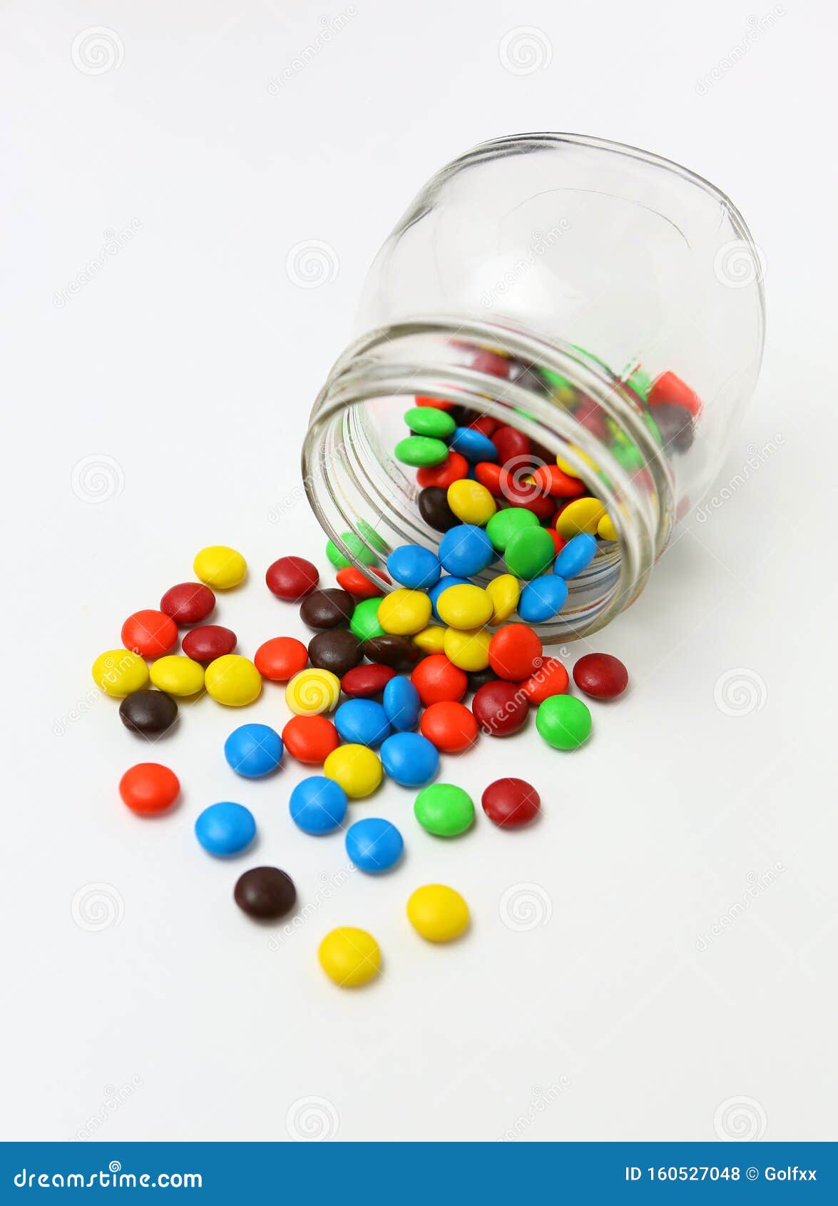 Colorful Sugar-coated Chocolate Smarties in a Glass Jar Flowing Out on ...