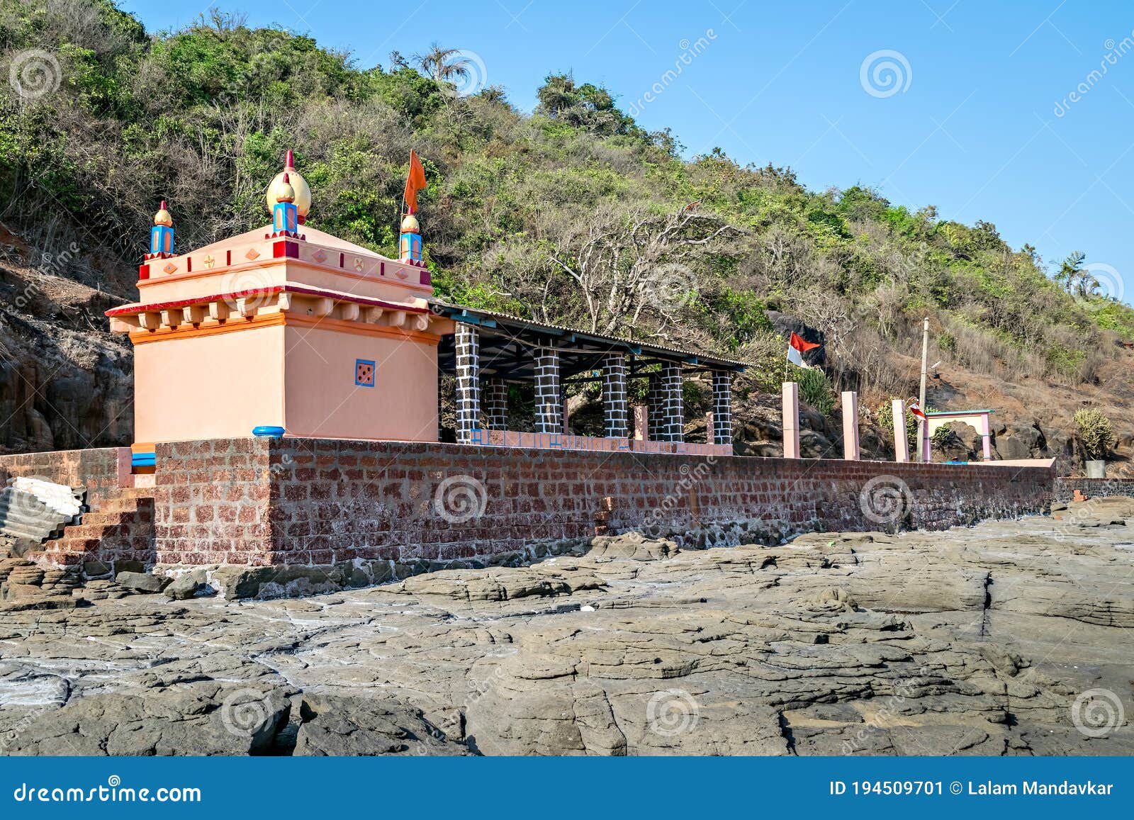 colorful temple of goddess uma maheshwari on rocky shore