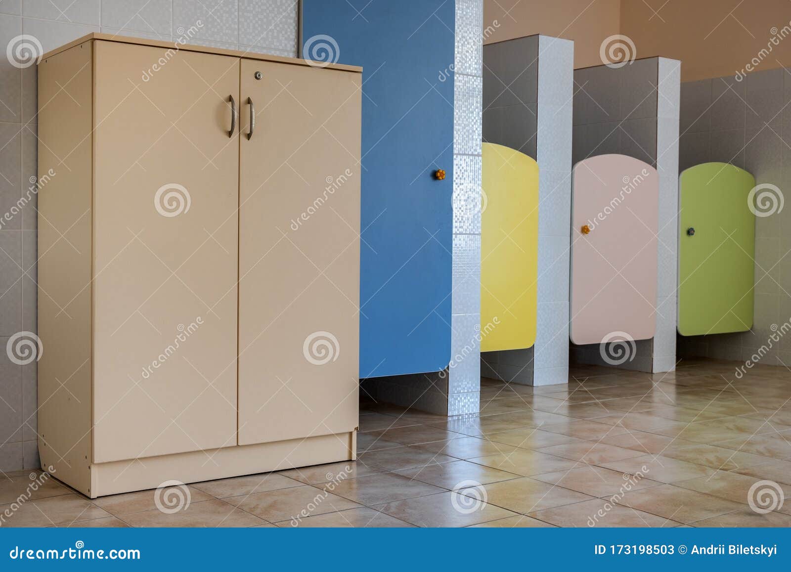 Colorful Toilet Doors in Elementary School Bathroom Interior Stock