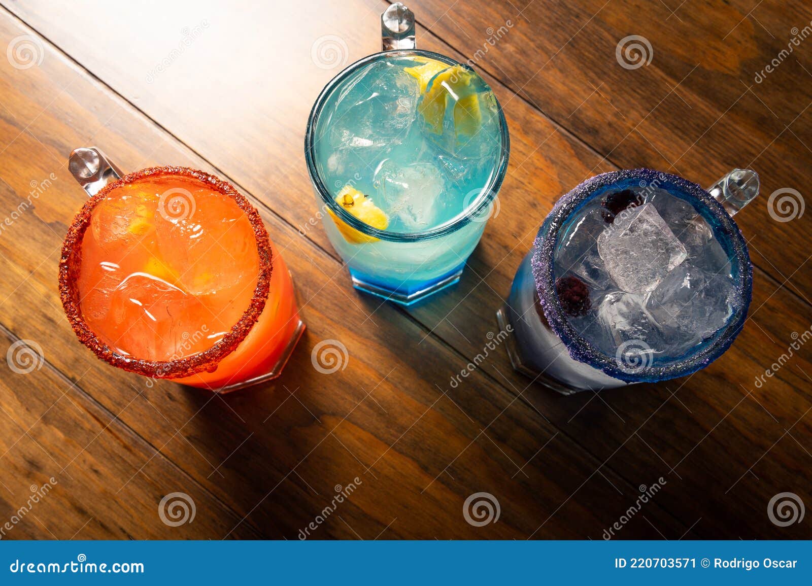 colorful toned cocktails on wooden background. frutal alcoholic cocktails. colorful drinks concept on wooden table