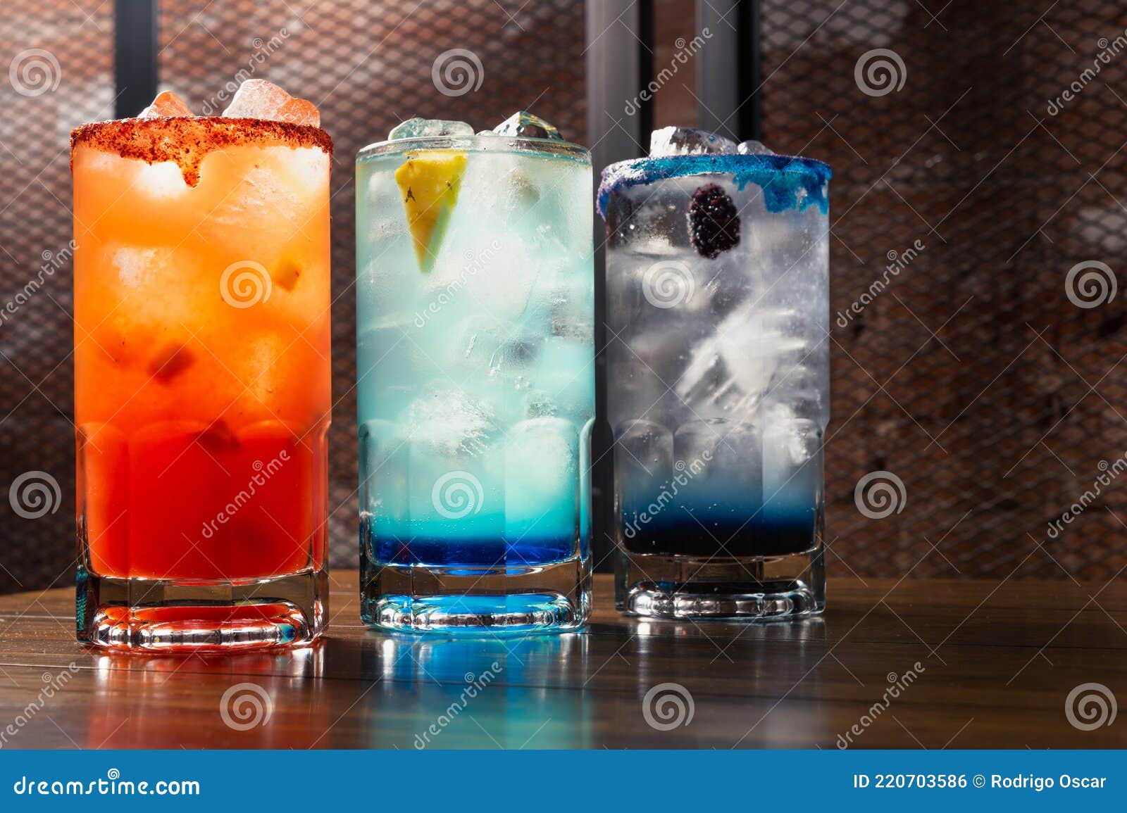 colorful toned cocktails on wooden background. frutal alcoholic cocktails. colorful drinks concept on wooden table.