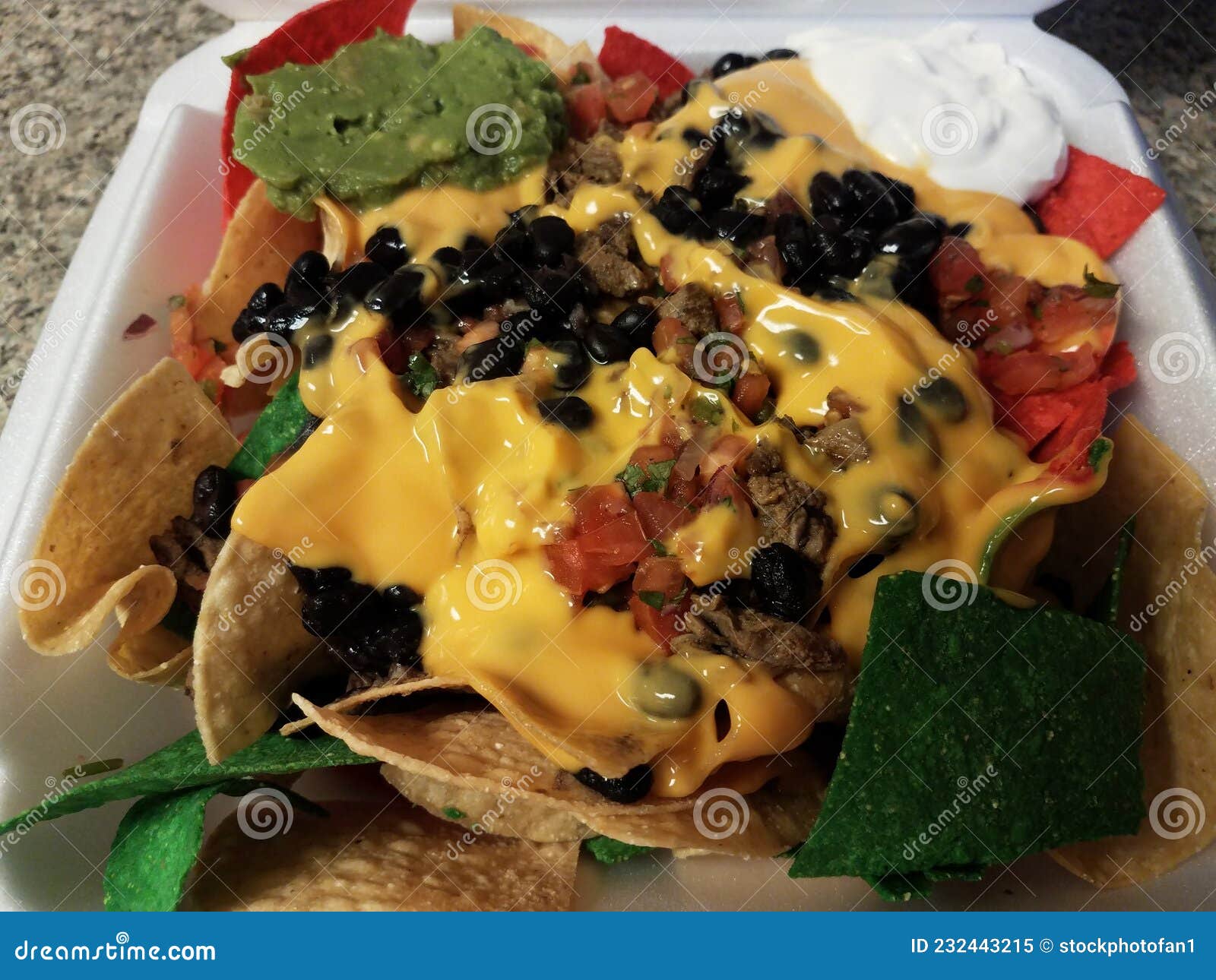 Colorful Tortilla Chips with Cheese and Beans in Box Stock Image