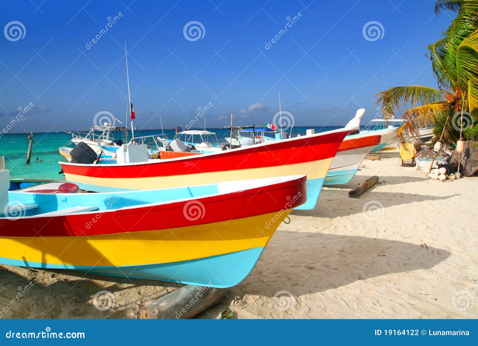colorful tropical boats in sand isla mujeres