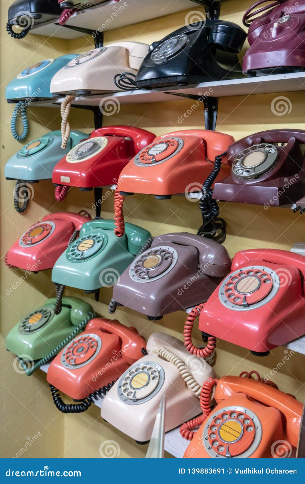 Collection of Colorful Vintage Retro Phone on Wooden Shelf for