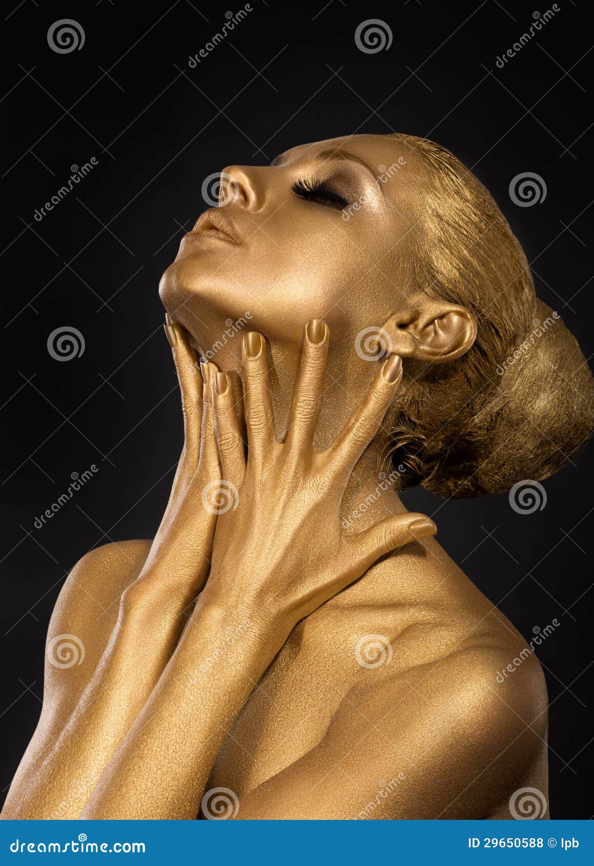 coloring. gilt. golden plated woman's face. art concept. gilded body. focus on her hands
