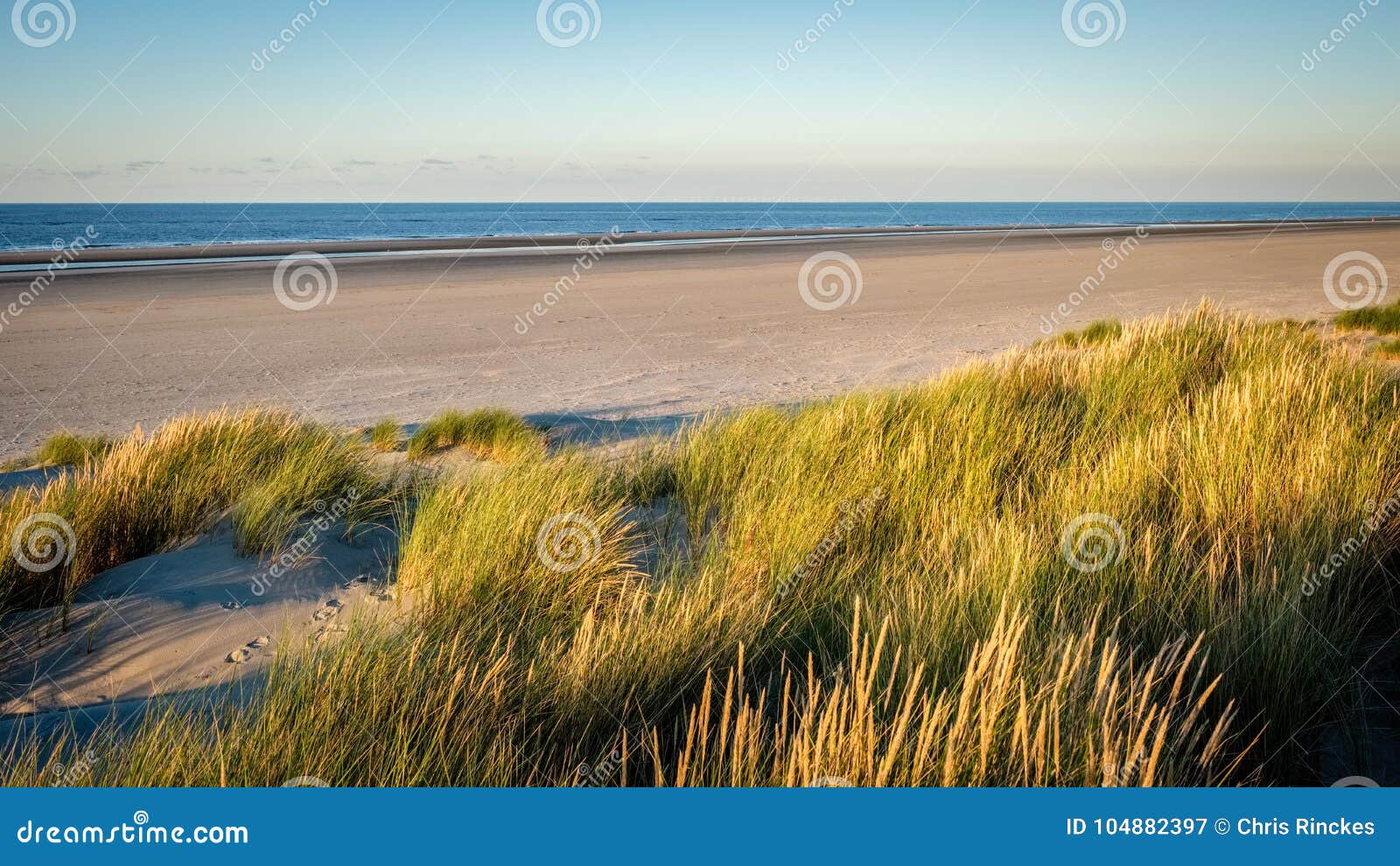 the sun is setting on the beach of schiermonnikoog friesland, netherlands