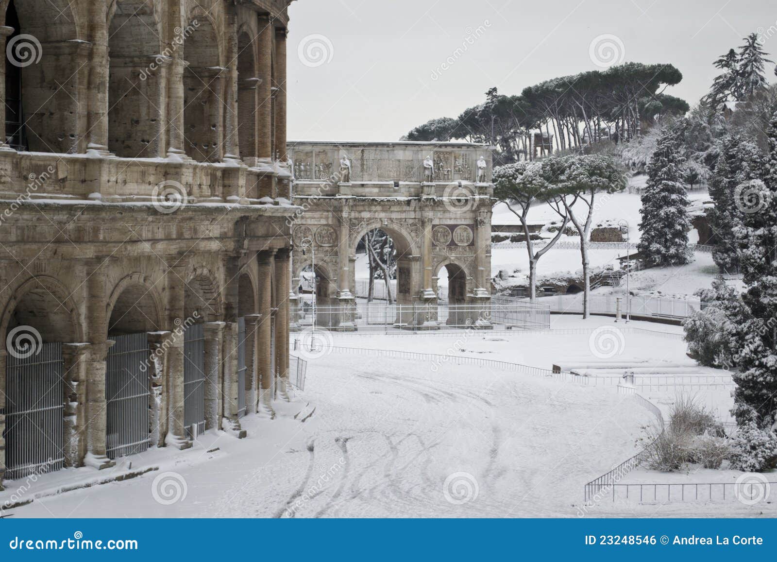 colosseum and costantine's arch in the snow