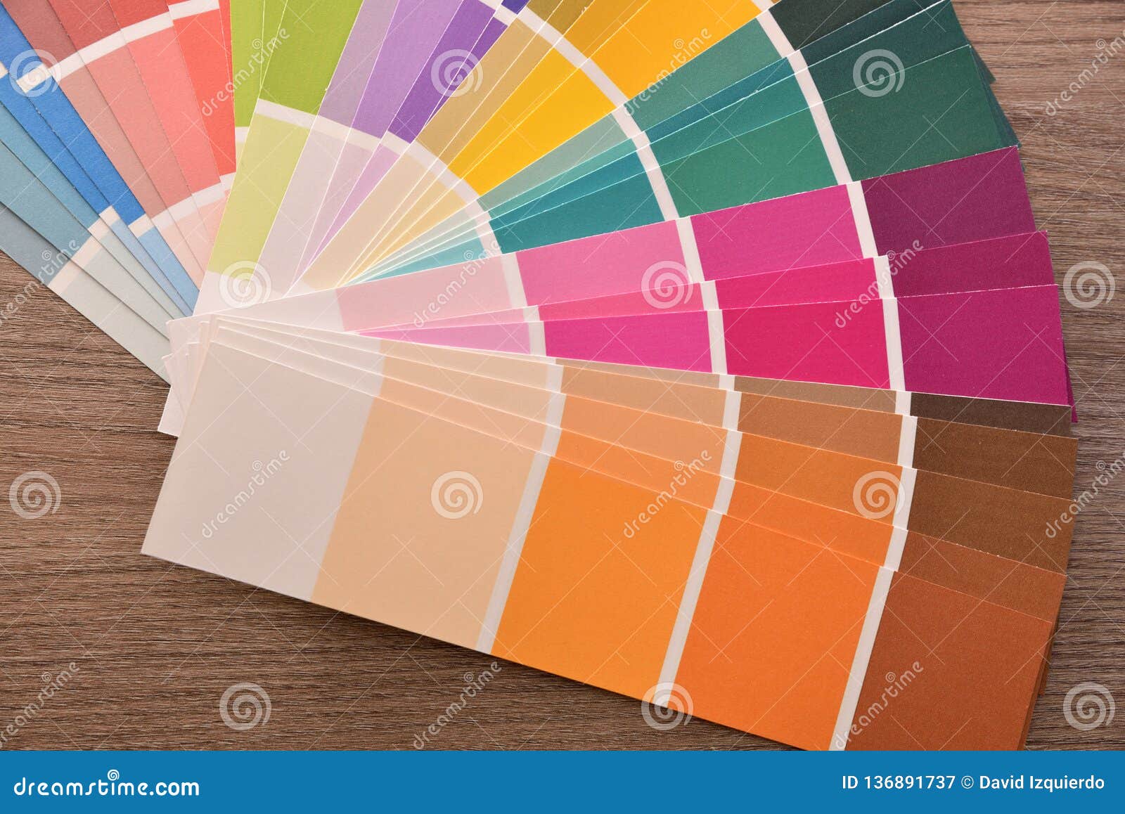 colour palette in fan on wooden table close up top