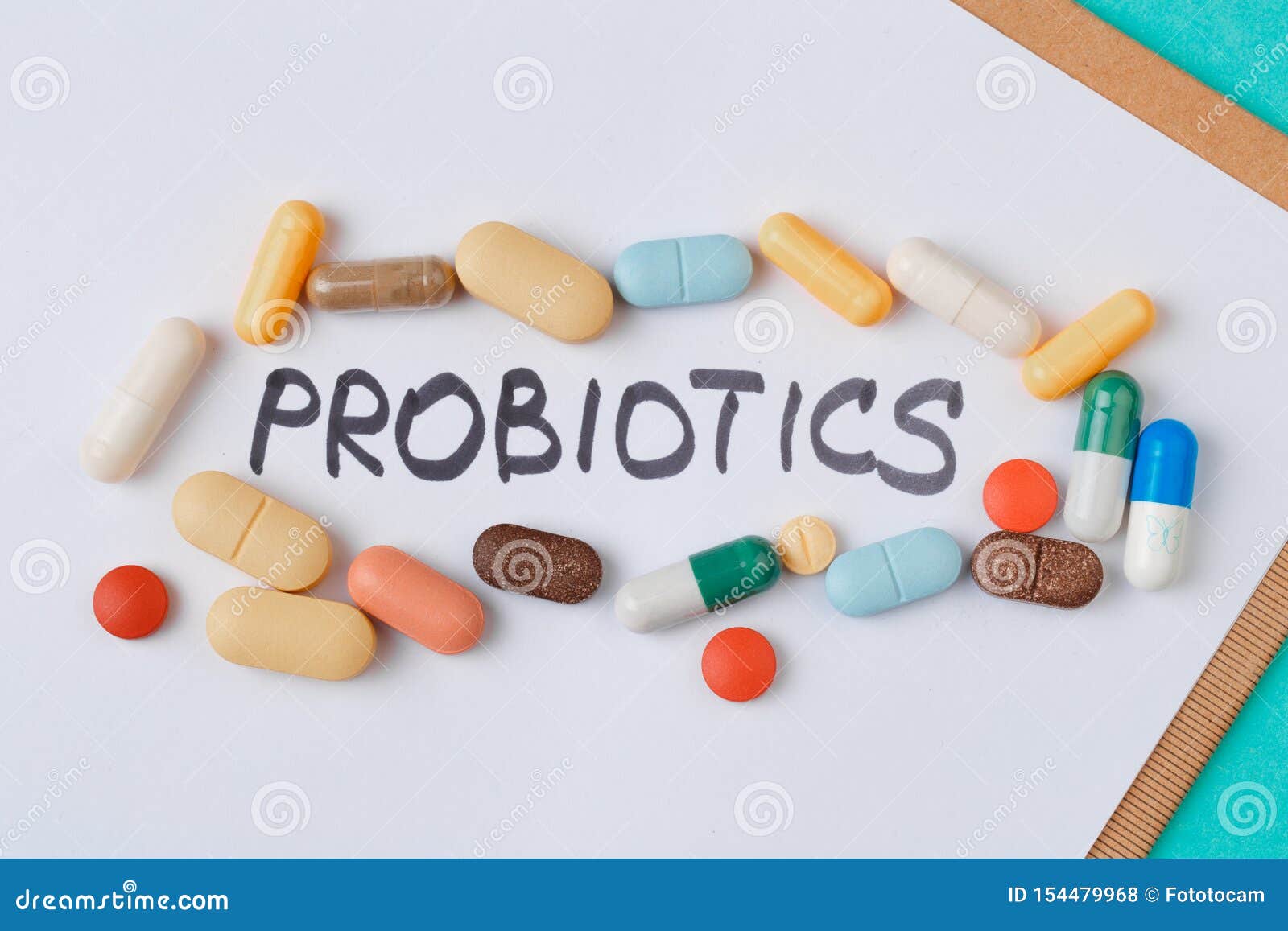 colour tablets and pills on blue background probiotic theme  - image