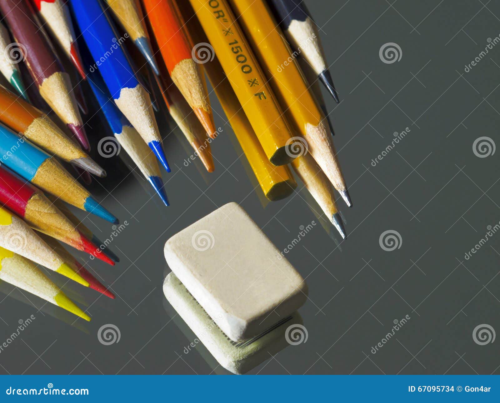 Coloured Pencils and Eraser on the Mirror Surface. Stock Photo Image