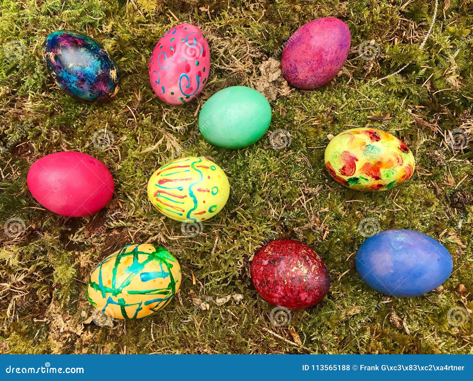 Happy Easter - Colourful Easter Eggs in Green Moss. Stock Photo - Image