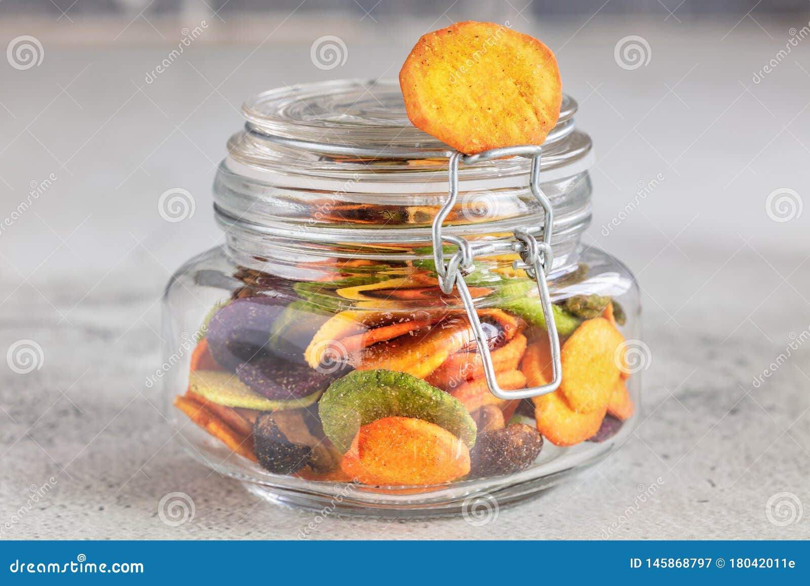 Colourful Mix Vegetable Chips in Glass Jar on Light Gray Background