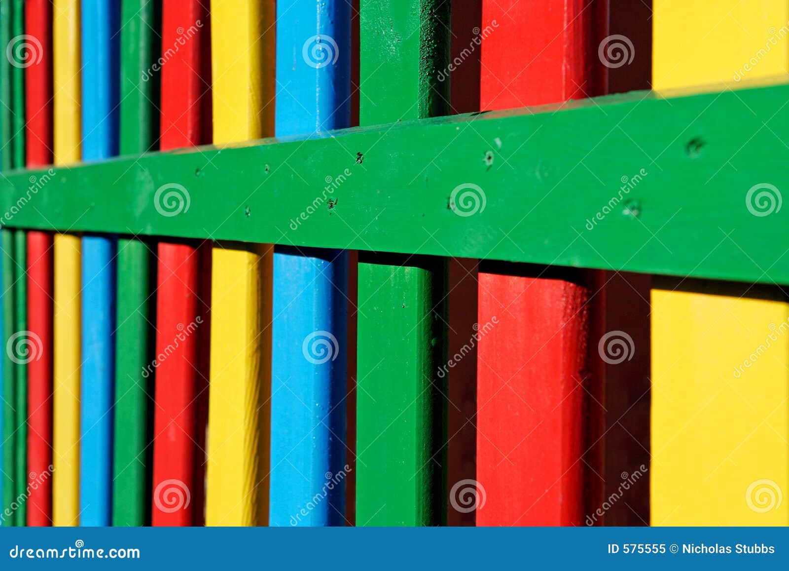 Colourful Rows of Painted Wood on a Playground Fence Stock Image
