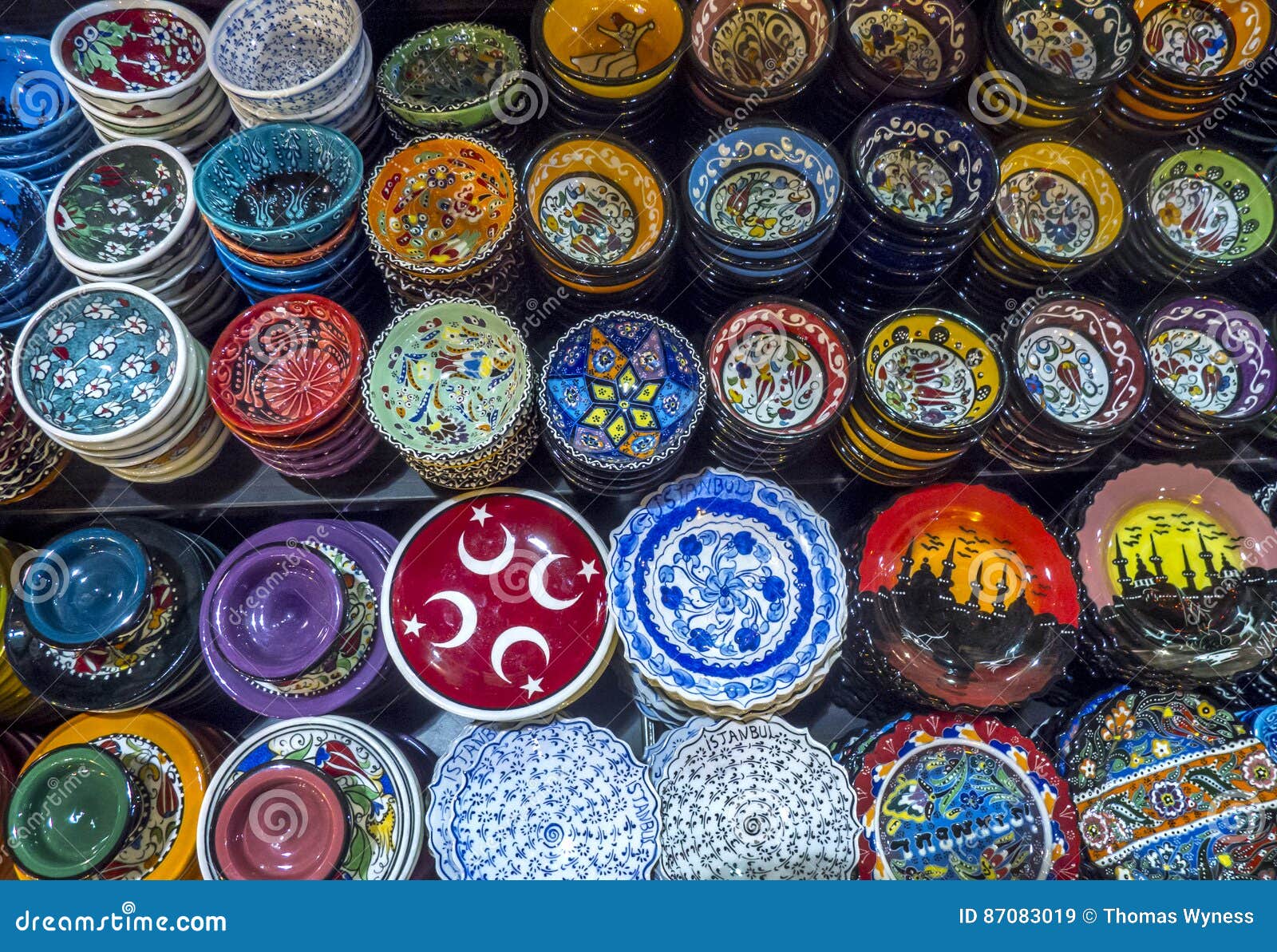 a colourful variety of plates and bowls on display at the spice bazaar in istanbul in turkey.