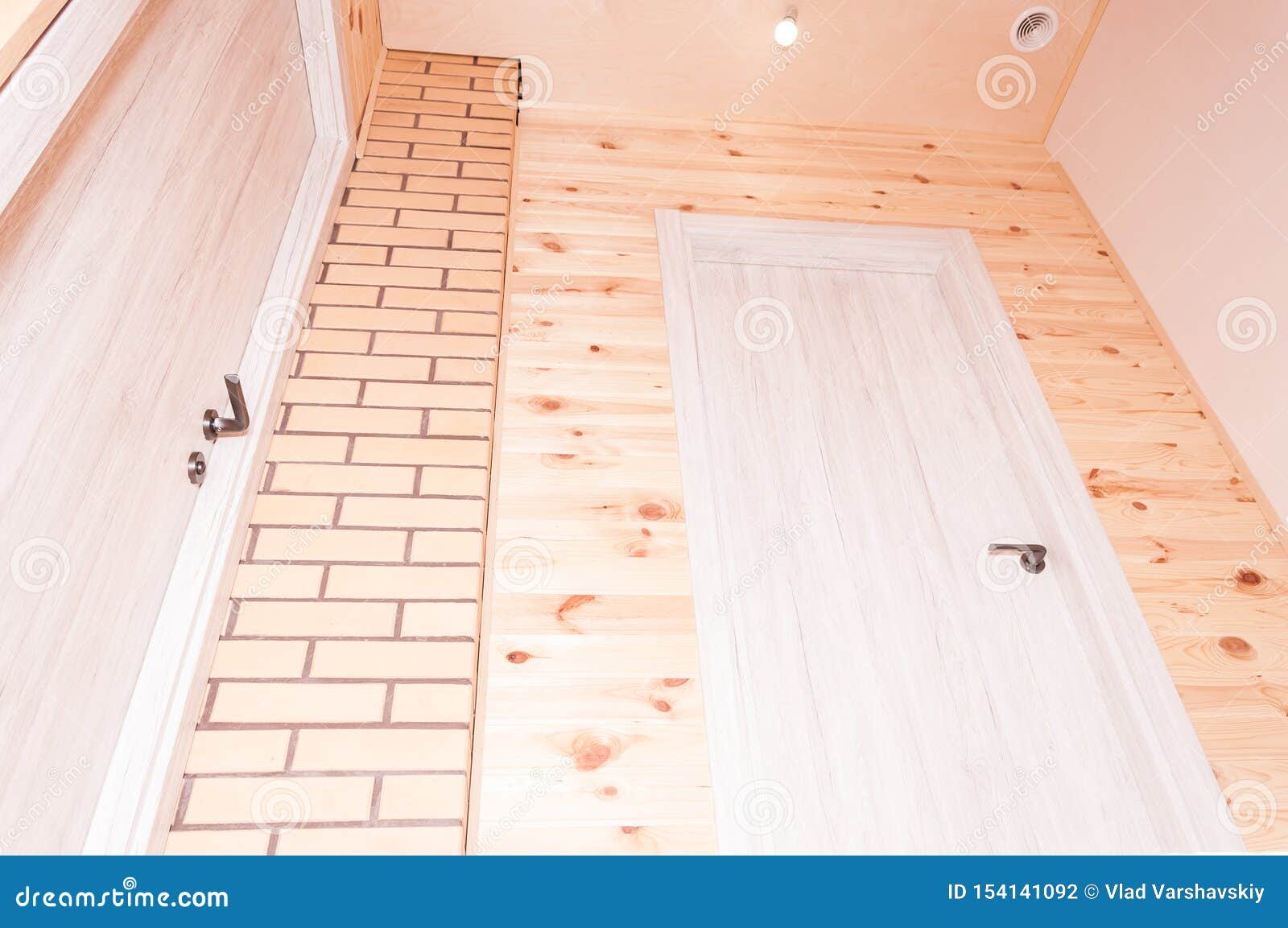 The Combination of Beige Decorative Brick with Pine Clapboard in the Interior Stock Photo