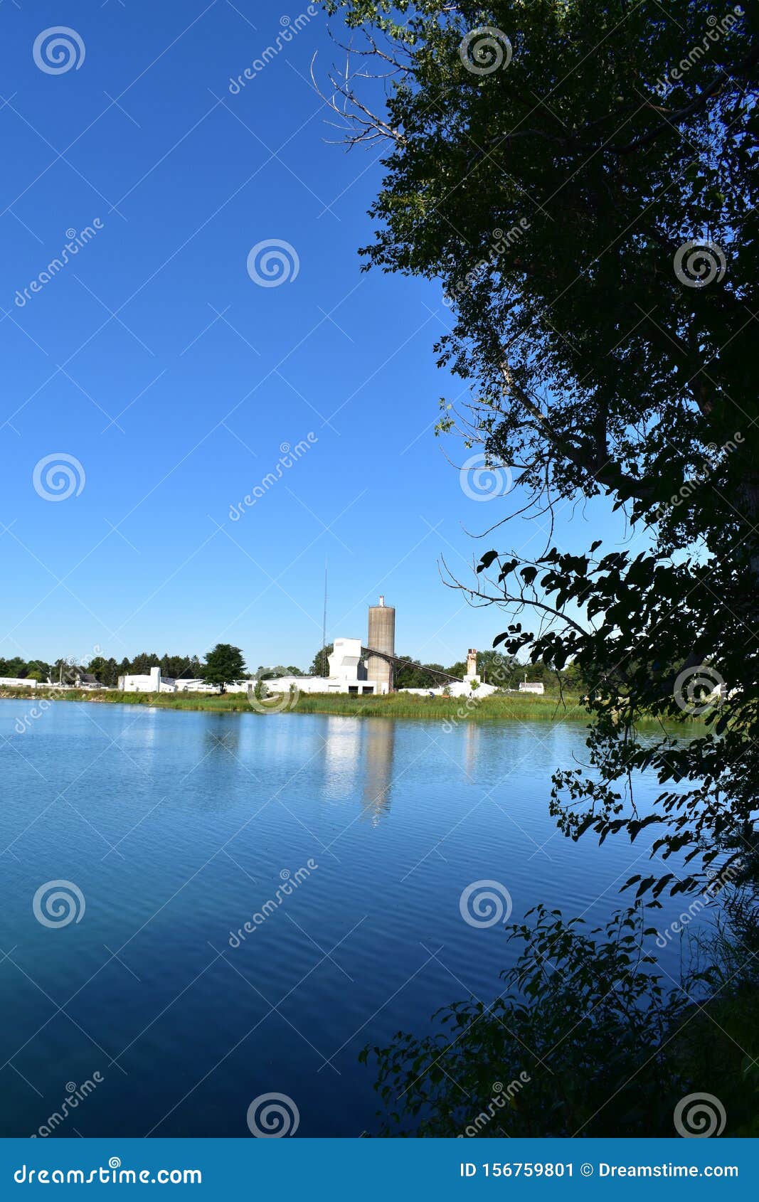 cement factory in the background of a beautiful lake