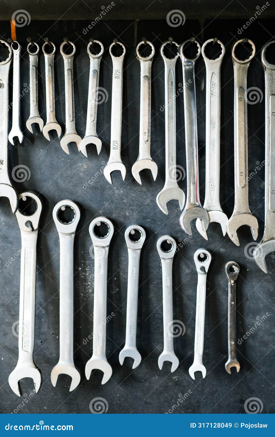 combination wrenches set in auto repair shop. mechanics repairing, maintaining car in garage.