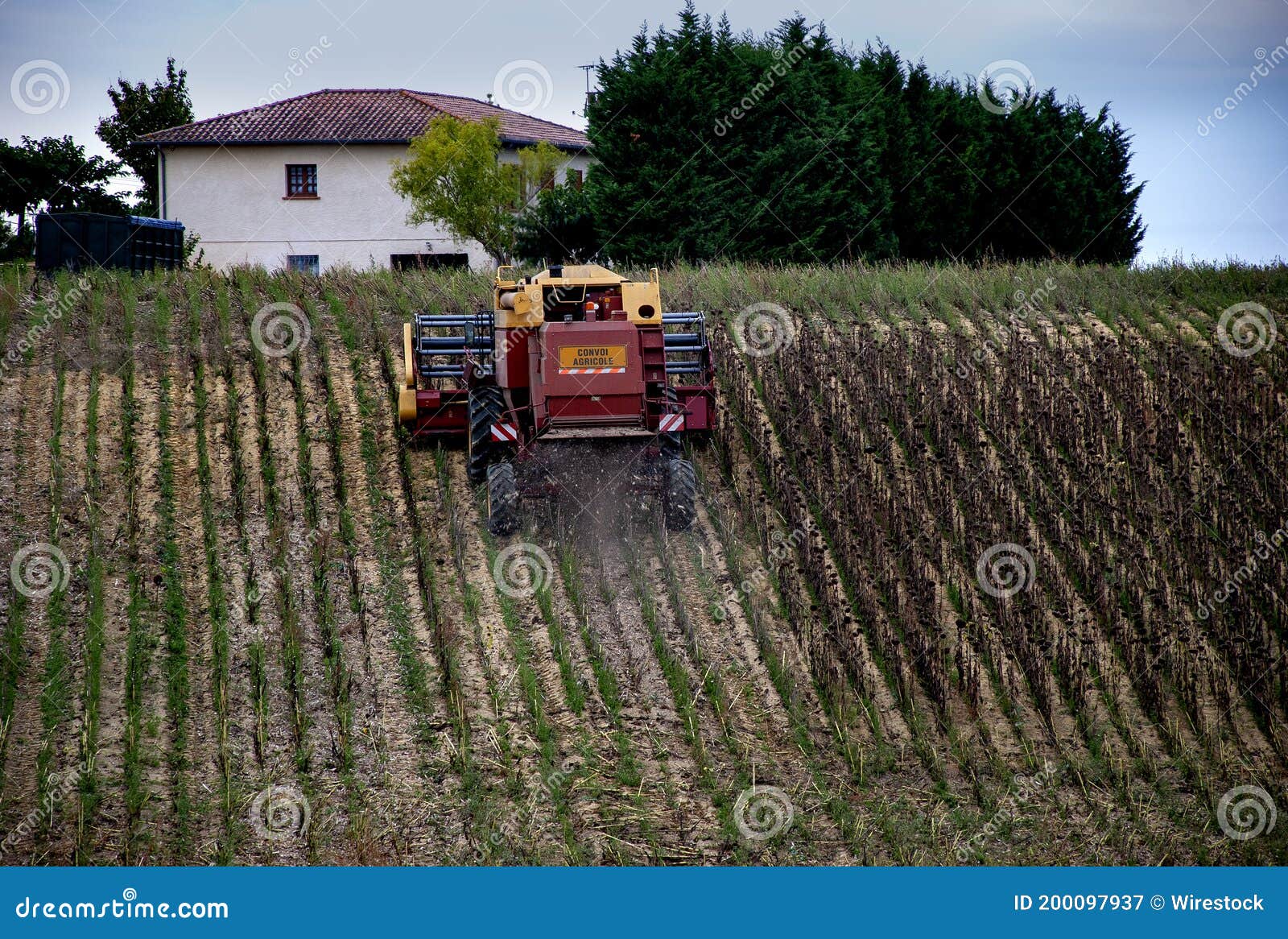 combine harvester type vehicle with 'convoi agricole' which is a warning to the following traffic
