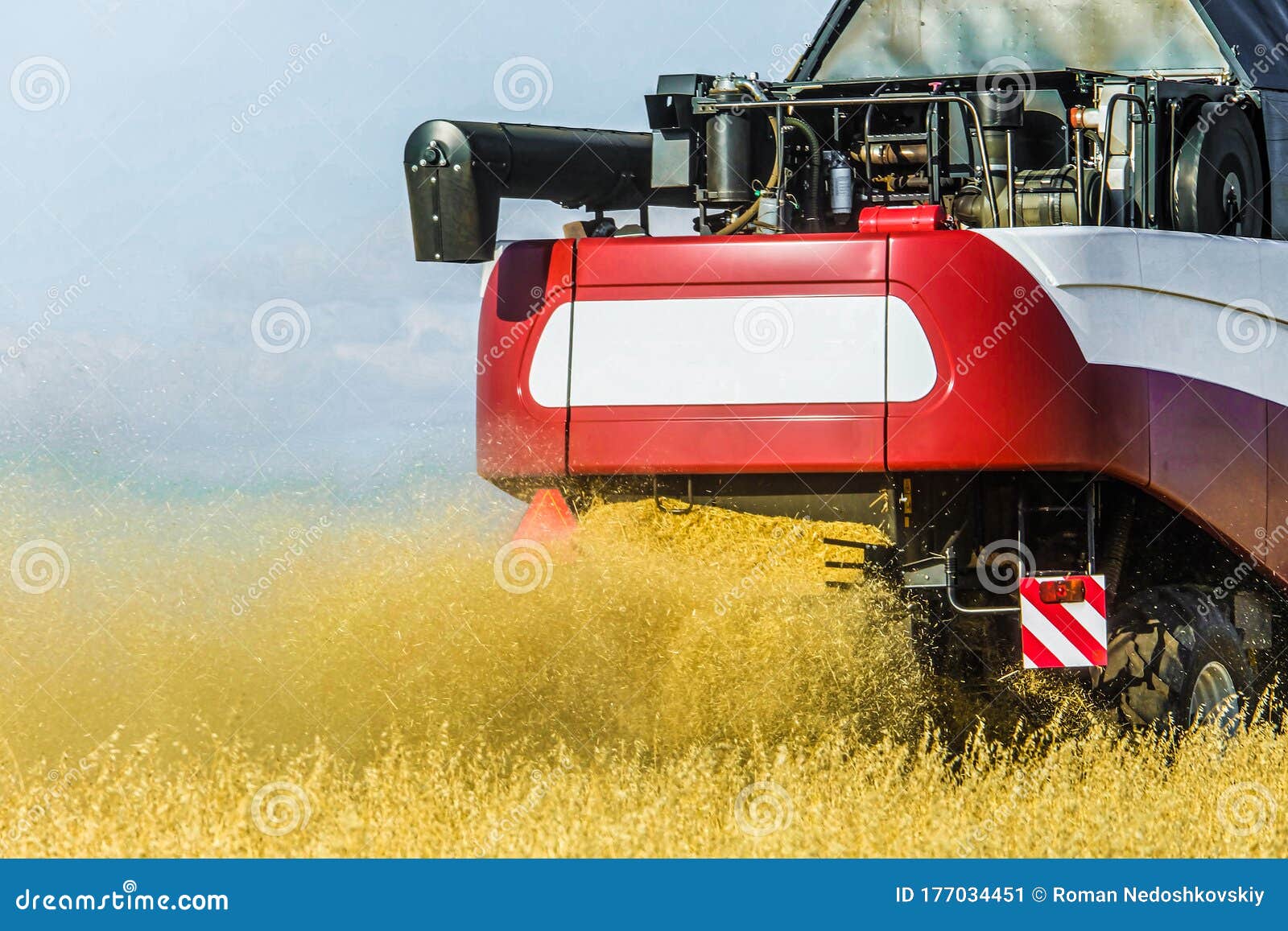combine harvester at work. back view close-up.
