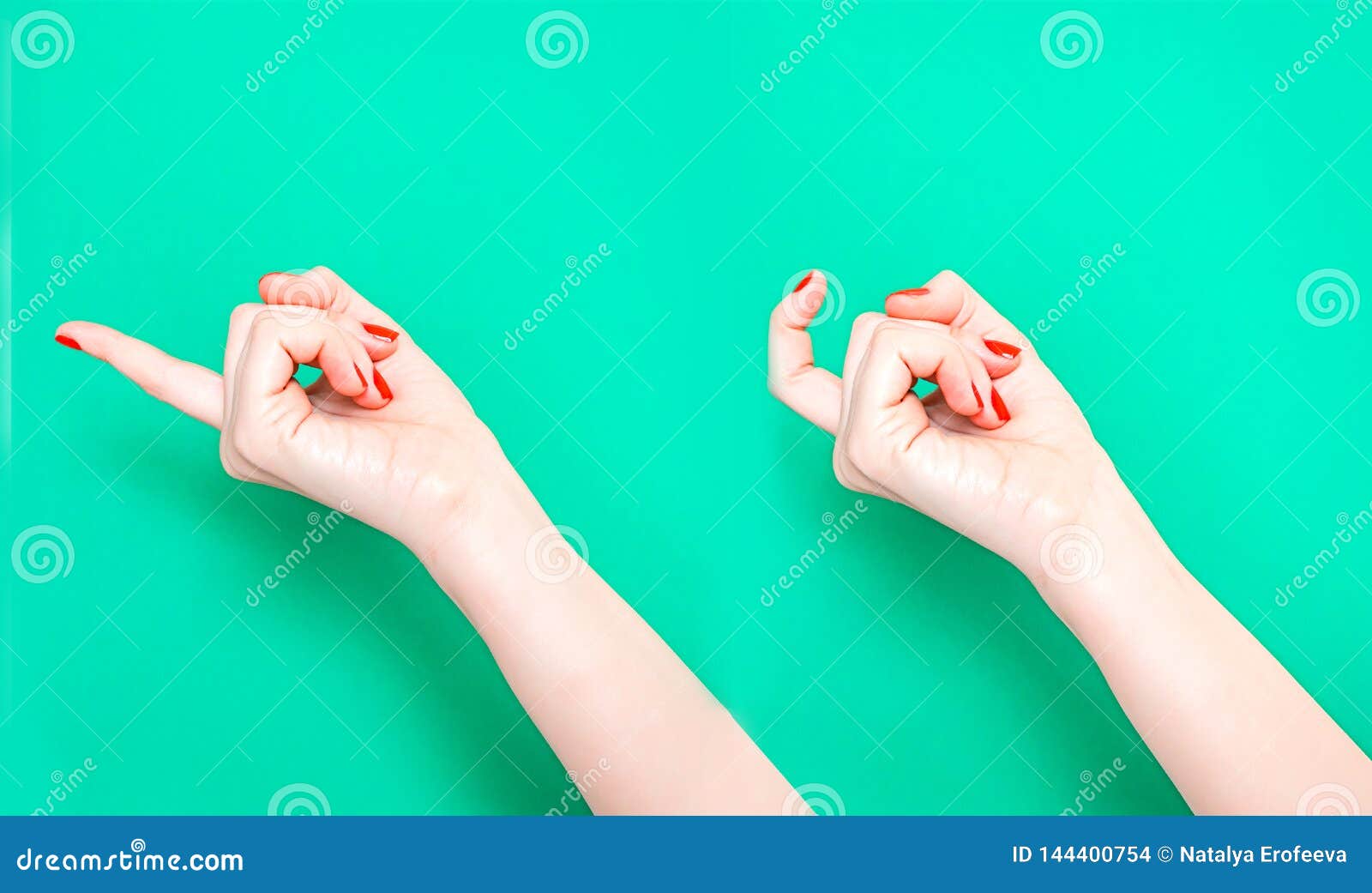 the come hither hand sign. woman hand beckoning on  turquoise green color background. female hand beckoning