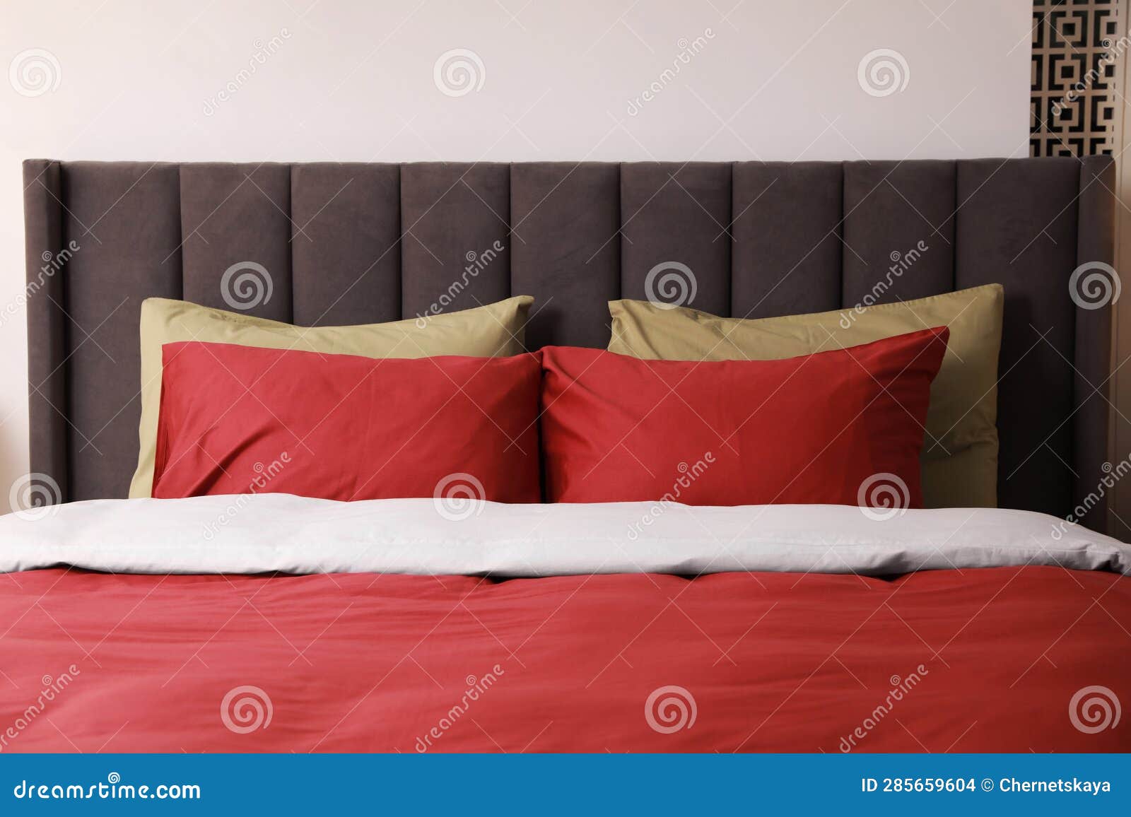 Comfortable Bed with Cushions in Room. Interior Design Stock Photo