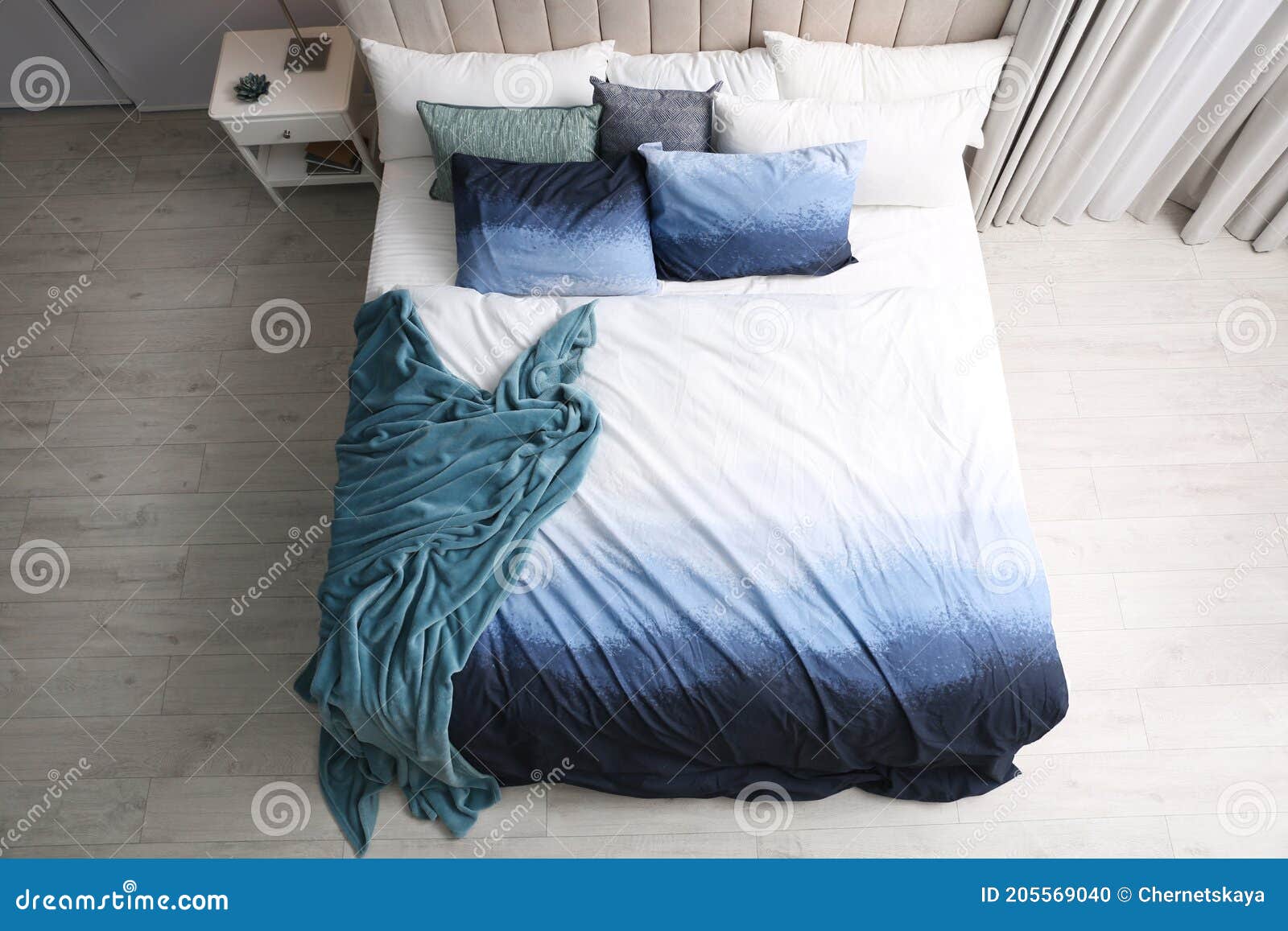 Comfortable Bed with Pillows and Soft Blanket in Room. Stylish Interior