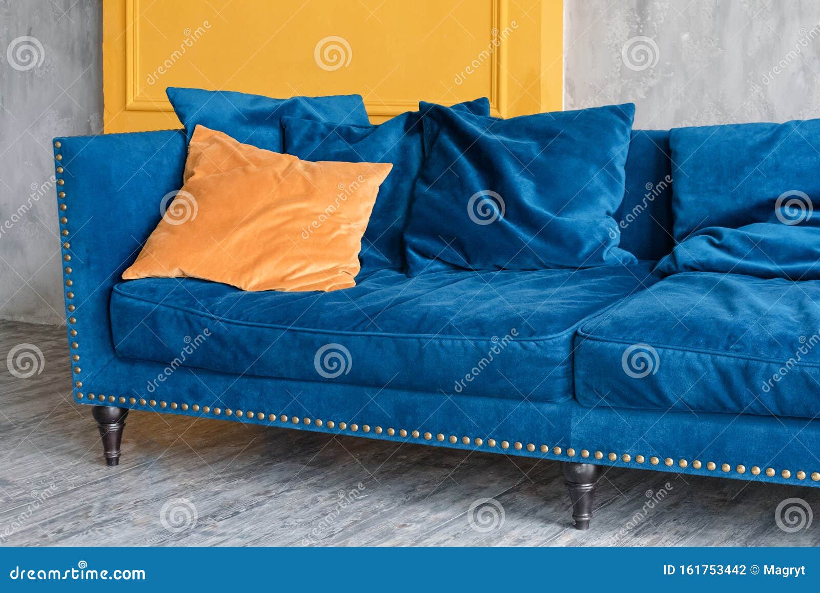 Comfortable Classic Blue Couch with Orange Pillows in Simple Minimalist