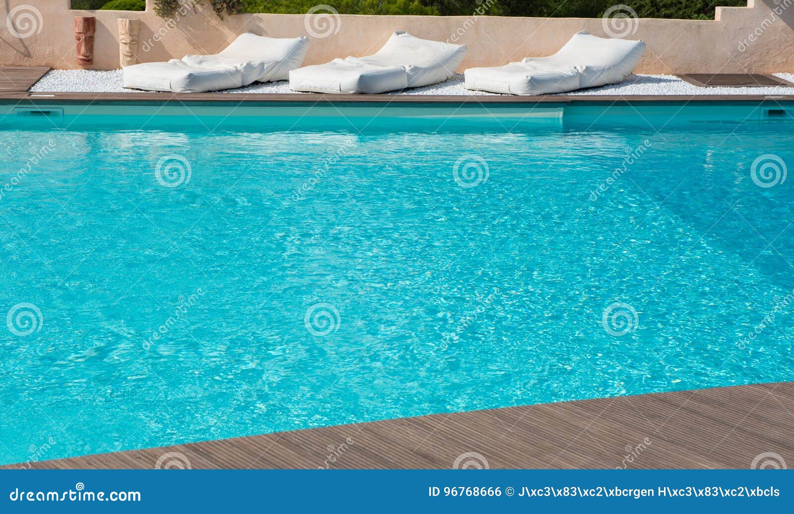 Comfortable Mattresses To Rest in the Pool with Turquoise Water Stock