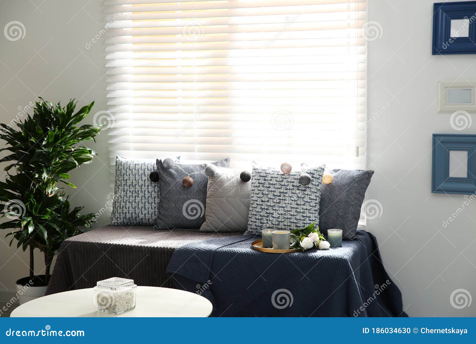 Comfortable Place for Rest with Cushions Near Window Stock Photo