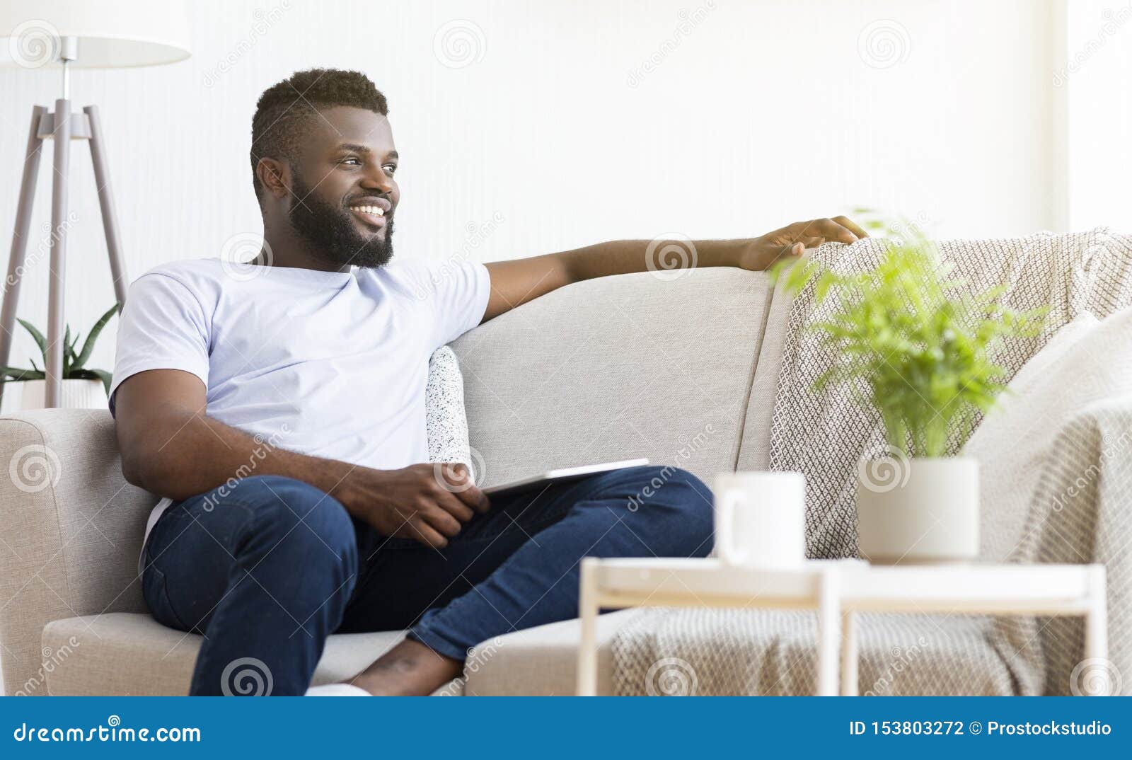 comfortable weekend. peaceful african man resting at home