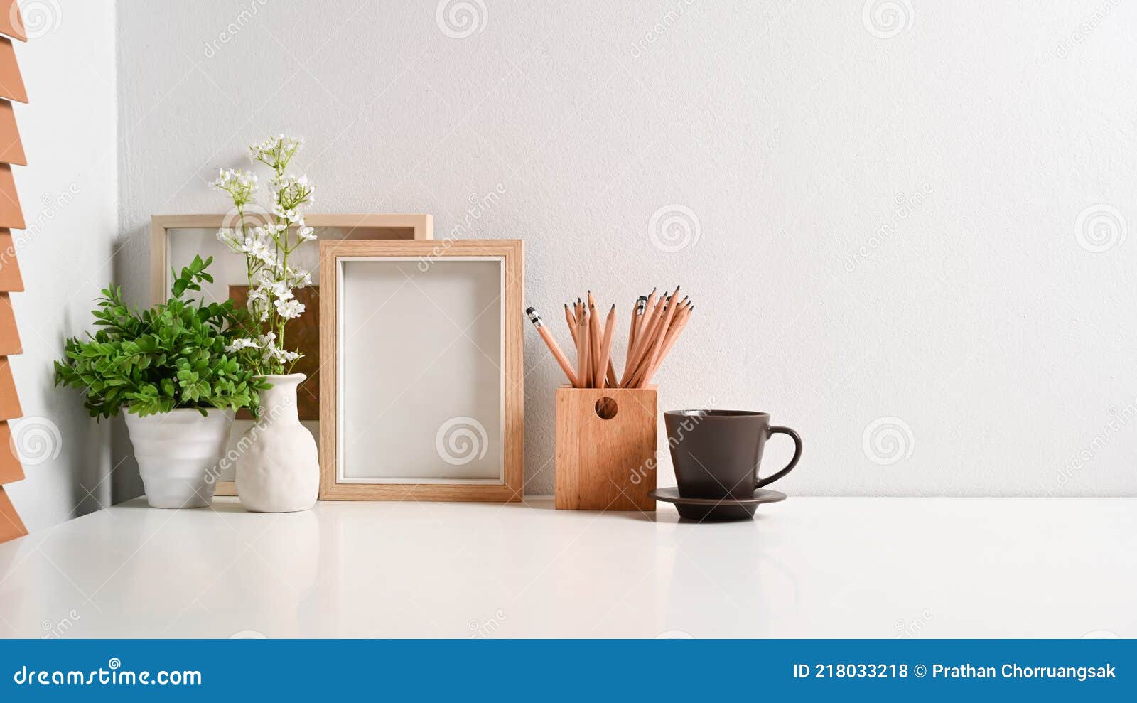 Comfortable Workplace with Empty Frame, Pencil Holder, Coffee Cup and