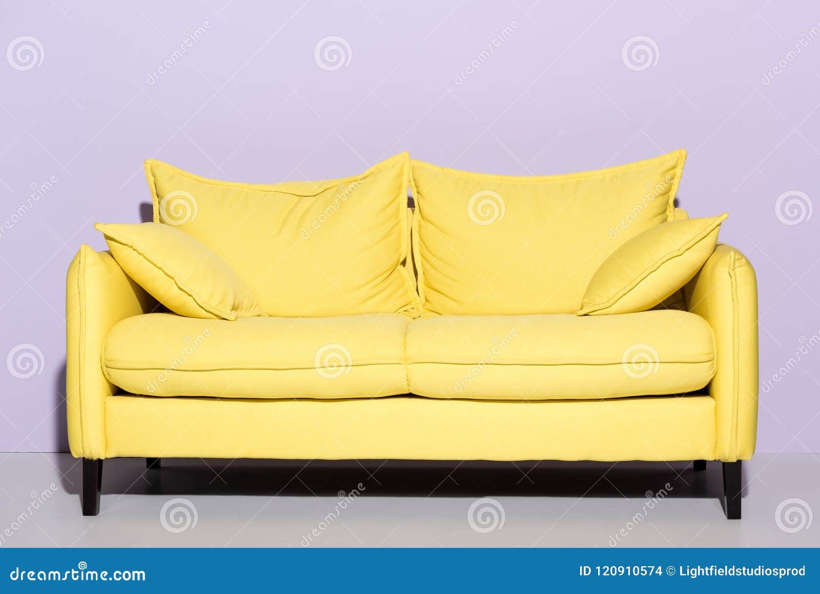 Old Yellow Couch With Cushions Sits On A Curb In Residential Area Next To A Recycling Cart