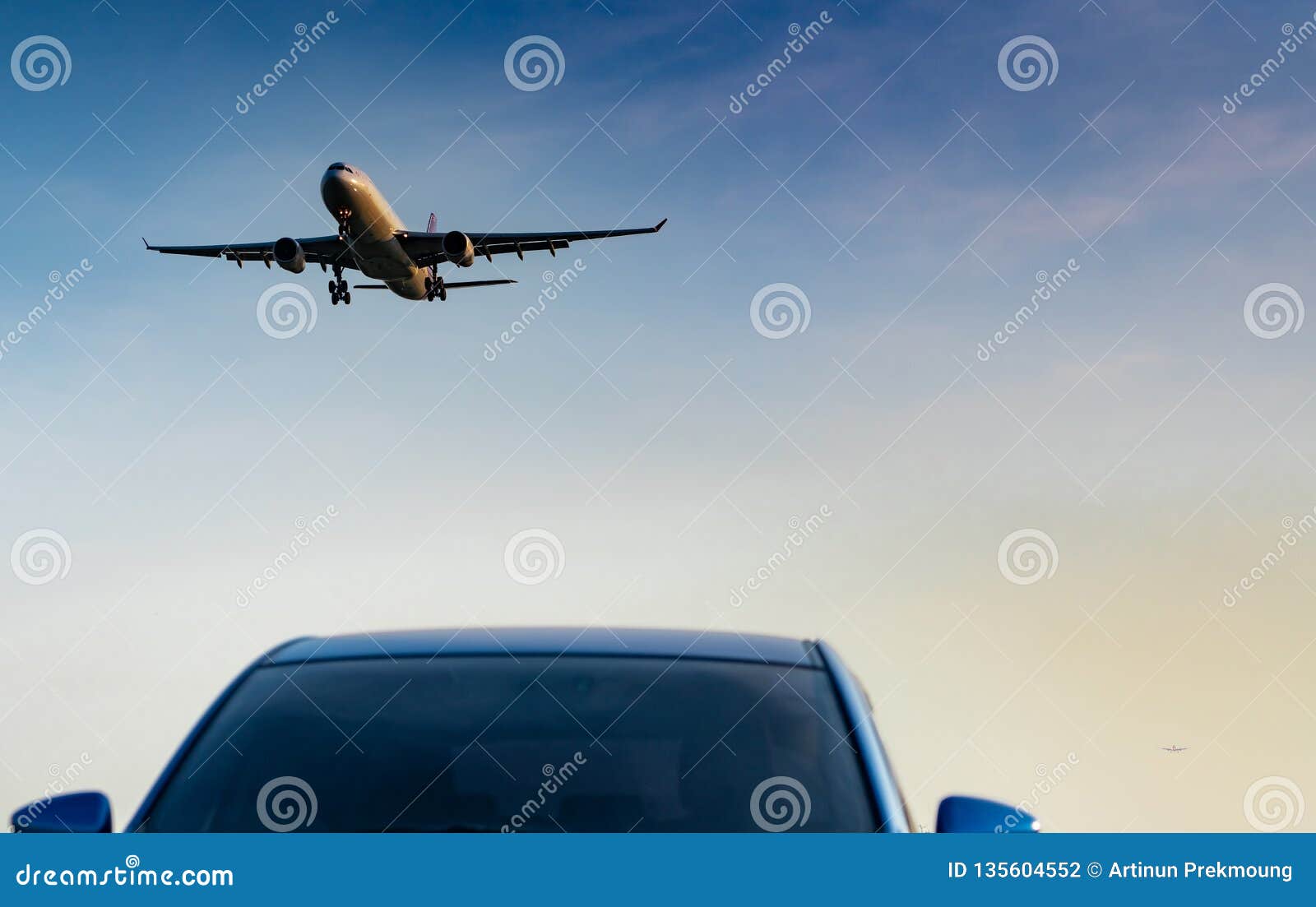 commercial airline. passenger plane landing approach blue suv car at airport with blue sky and clouds at sunset. arrival flight.