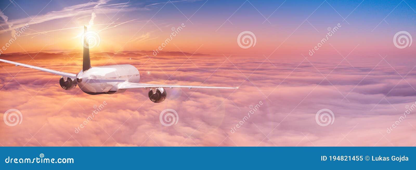 Commercial Airplane Jetliner Flying Above Dramatic Clouds. Stock Image