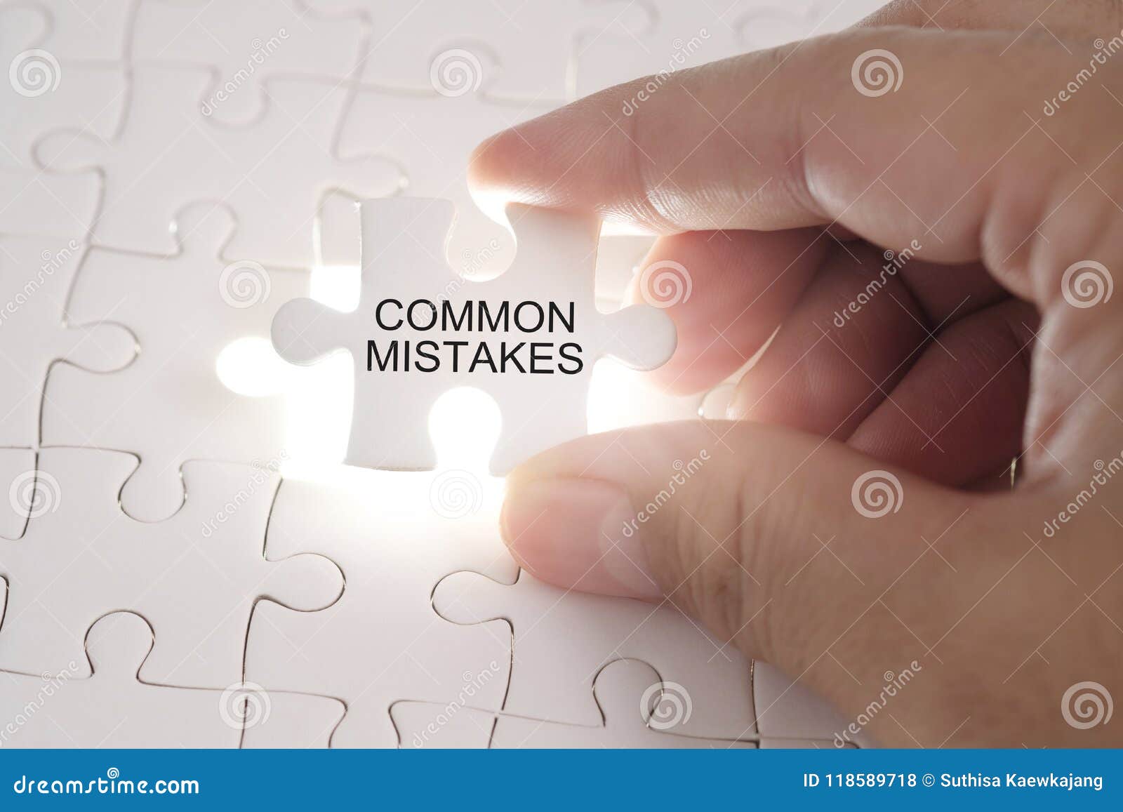 common mistakes word on jigsaw puzzle. businessman hands holding