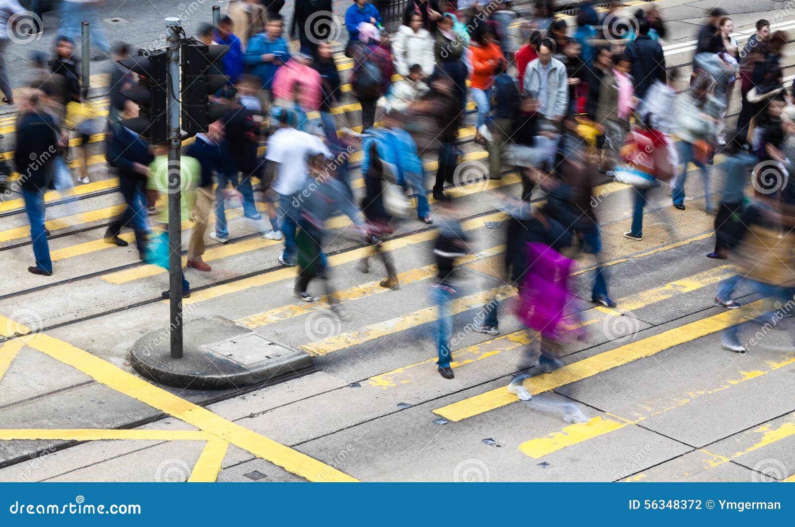 commuters crossing a busy crosswalk