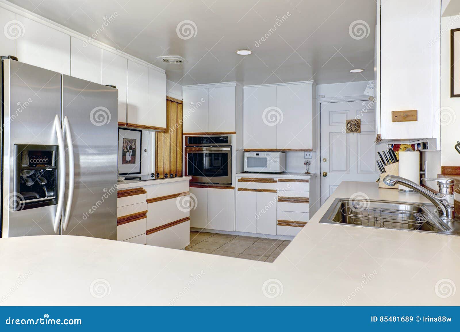 compact kitchen room with white cabinetry