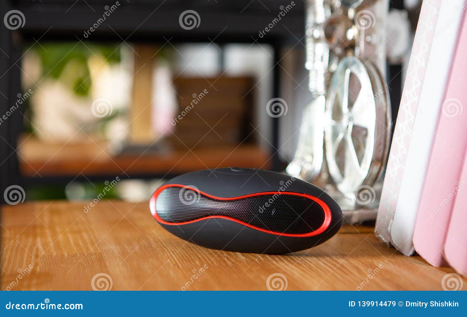 Compact Mini Bluetooth Speaker in the Interior on the Shelf in the