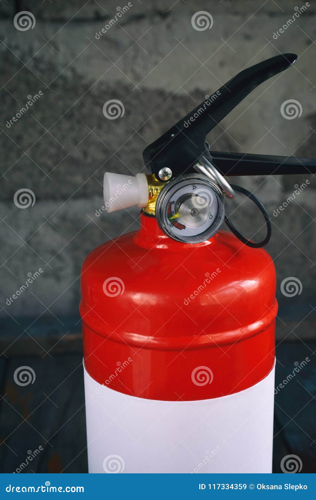 Compact Red Fire Extinguisher for Auto or Home on Grey Background. for Fire Emergencies. Stock