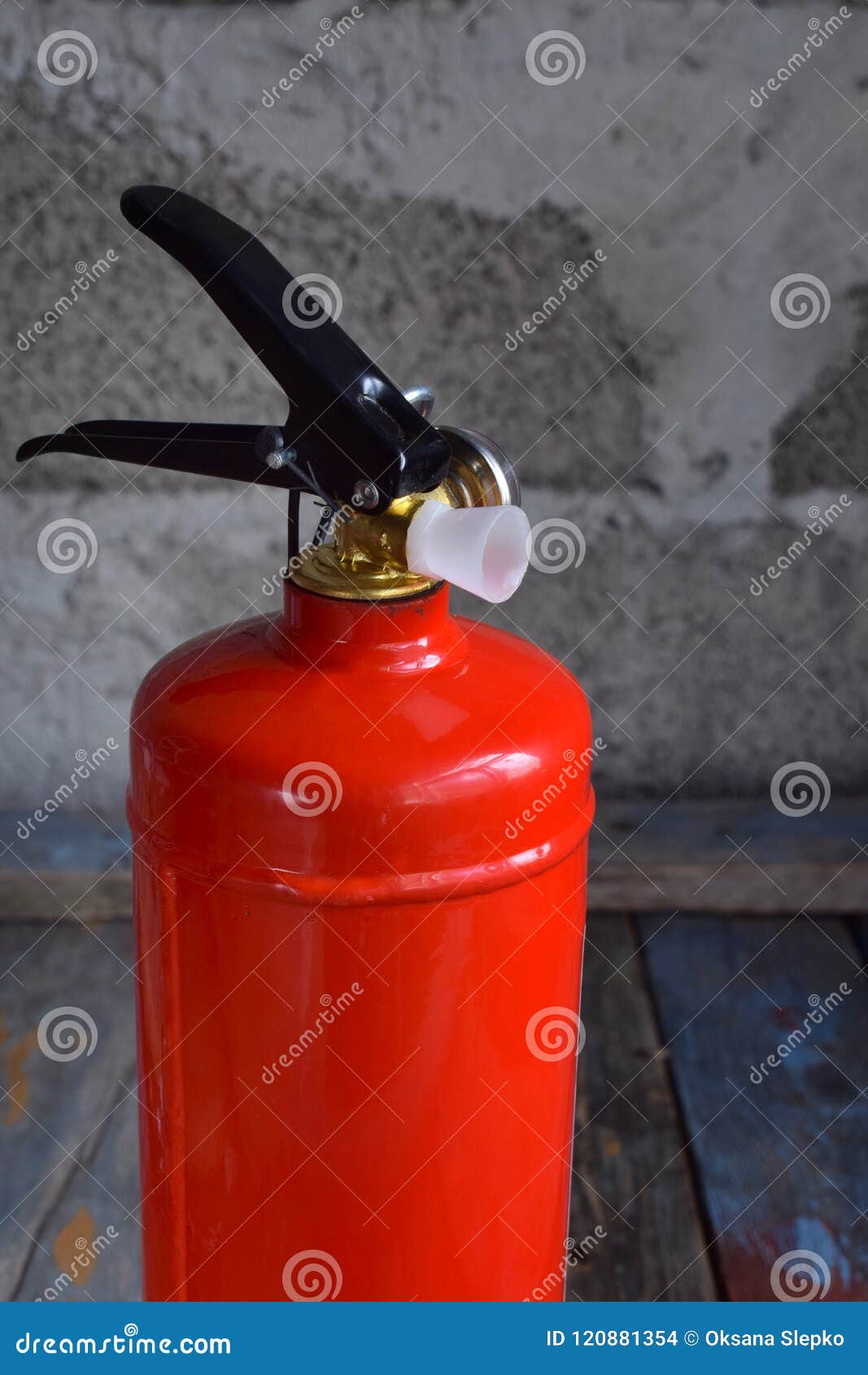 Compact Red Fire Extinguisher for Auto or Home on Grey Background. for Fire Emergencies. Stock