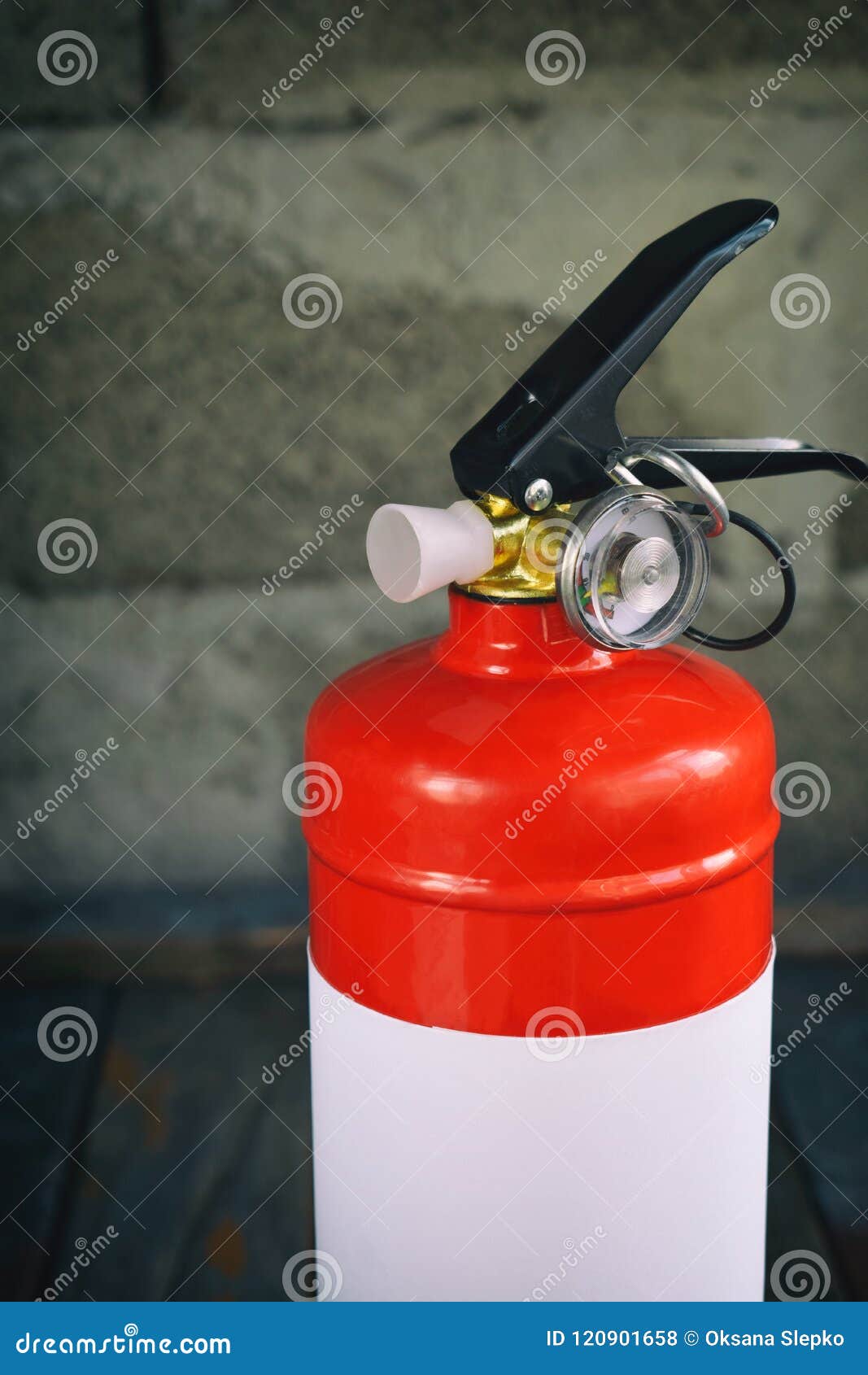 Compact Red Fire Extinguisher for Auto or Home on Grey Background. for