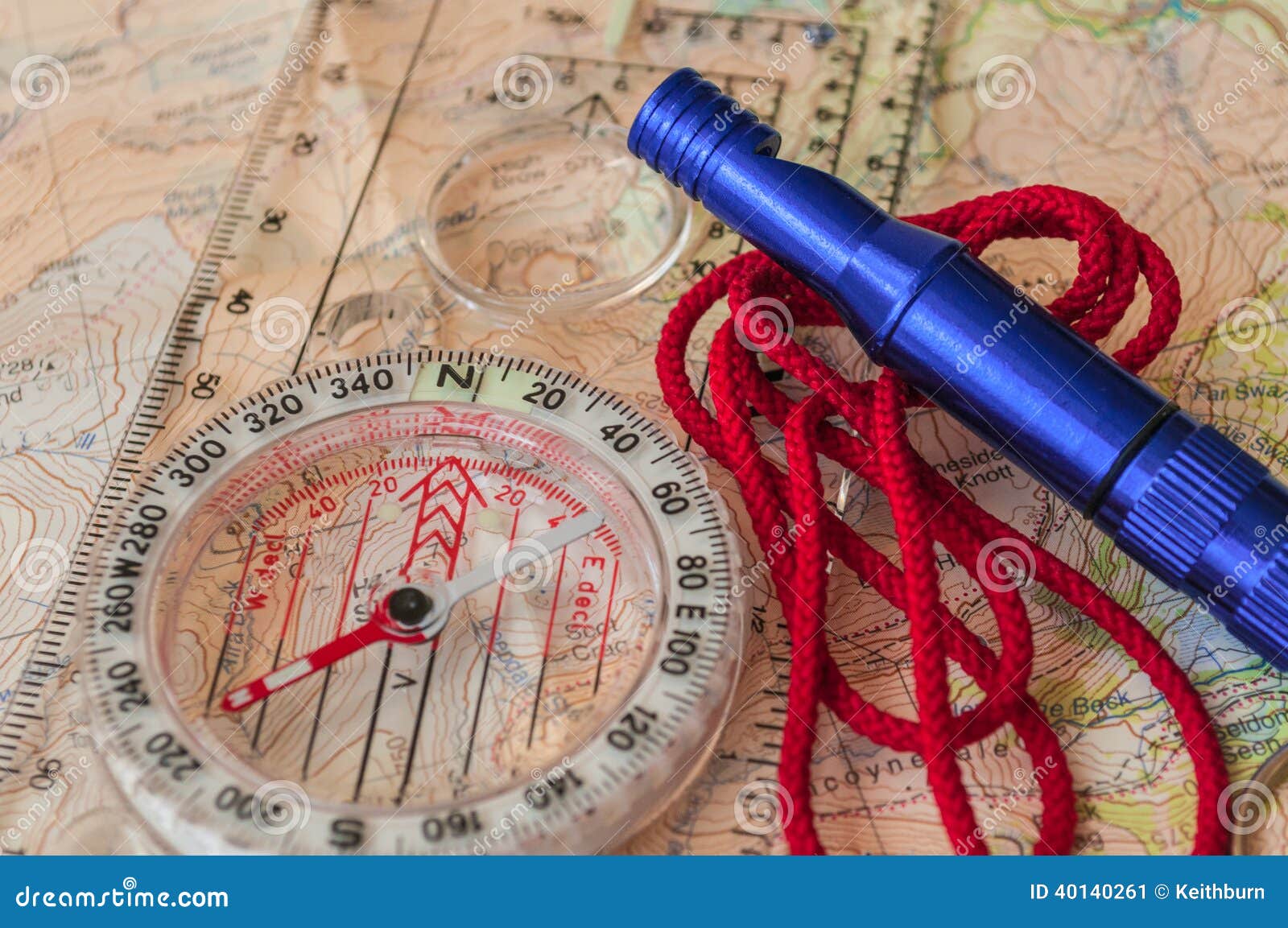 compass on map and rescue whistle