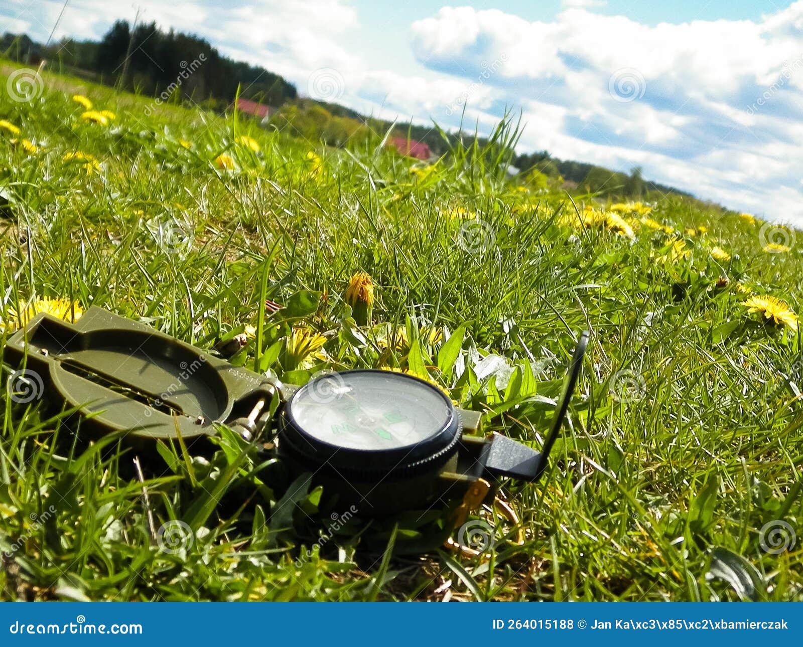 Compass on the Meadow Travel and Vacations Concept Stock Photo