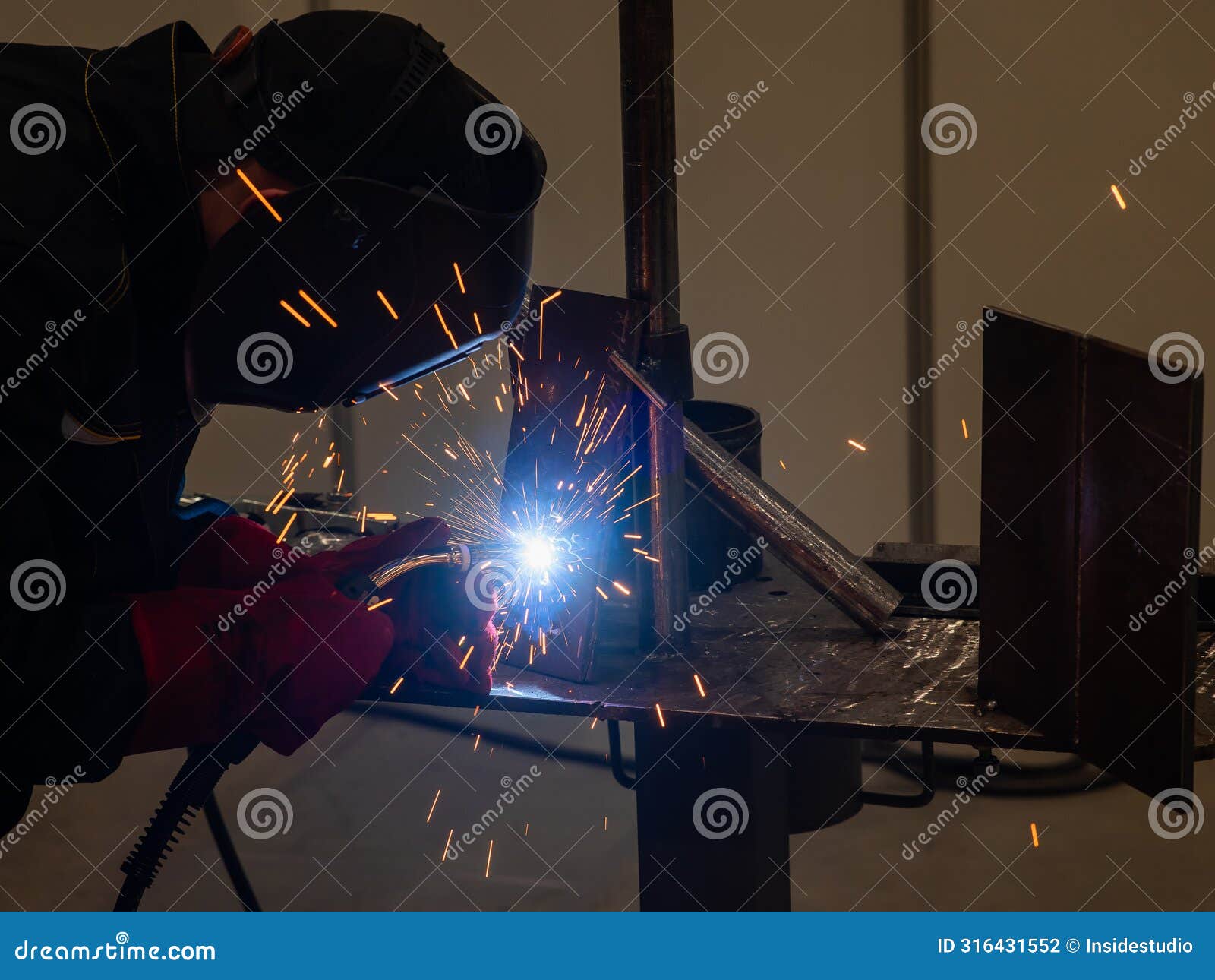 competitions among welders. a man in a protective mask is welding.